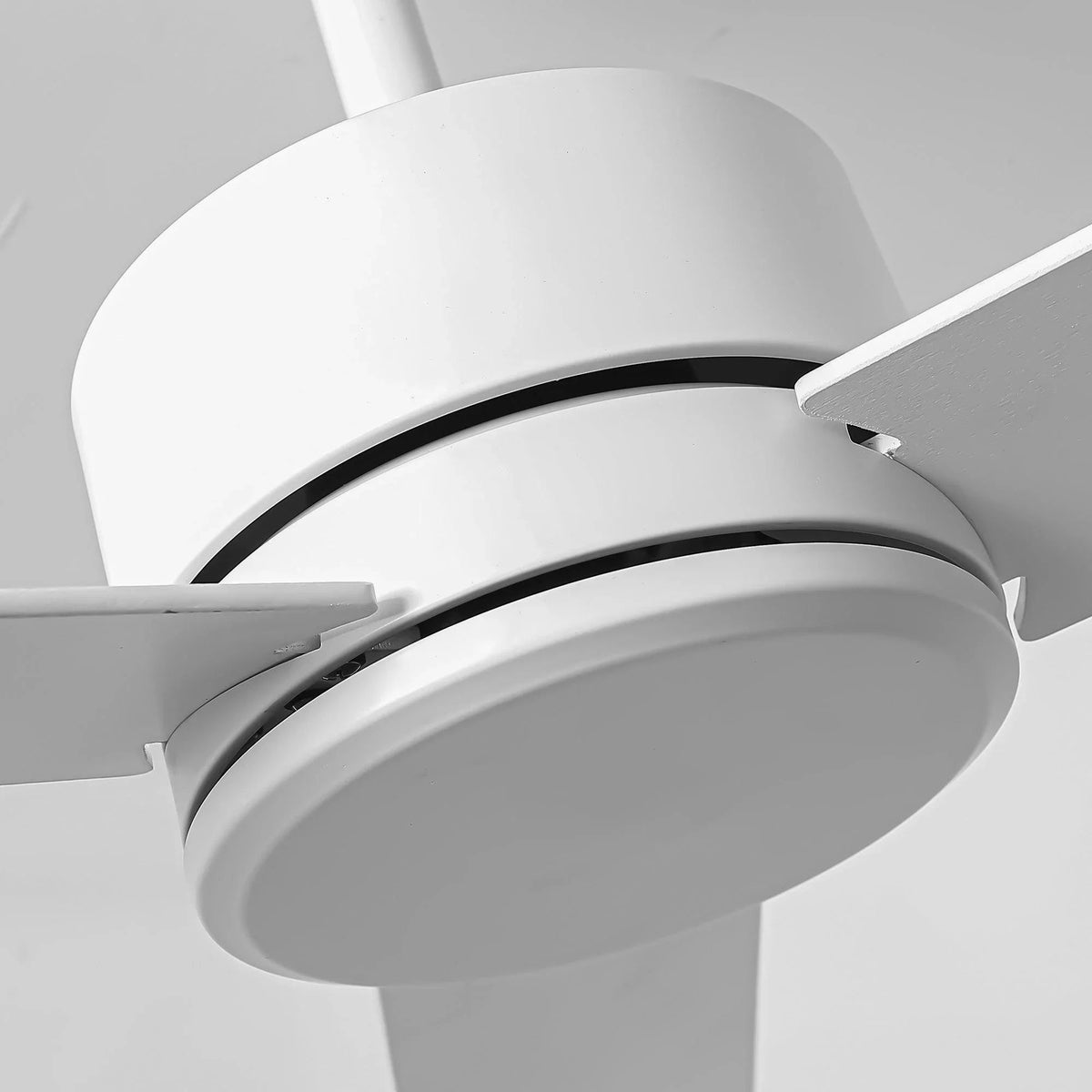 White downrod-mount ceiling fan canopy with curved housing and blade tips visible
