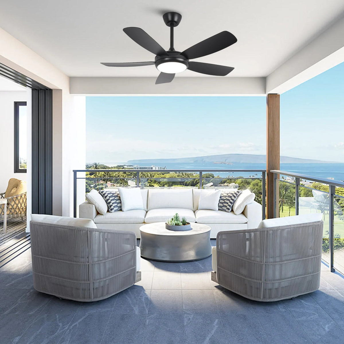 Black LED ceiling fan installed on patio ceiling above outdoor seating
