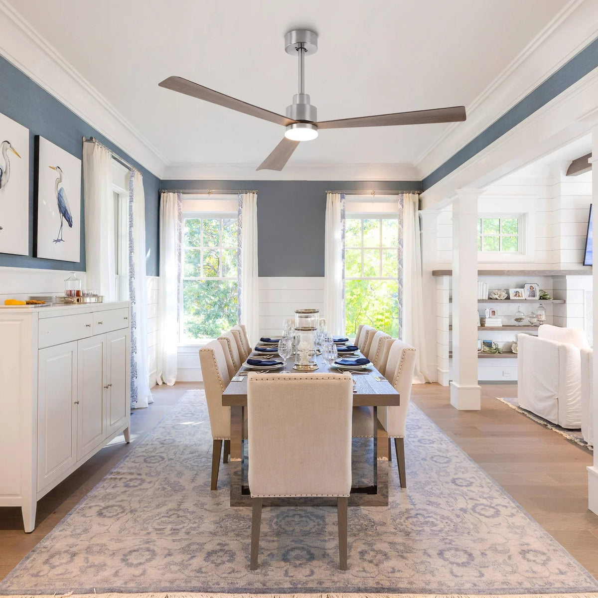 Ceiling-mounted modern fan with wood blades and central LED light kit in a dining room