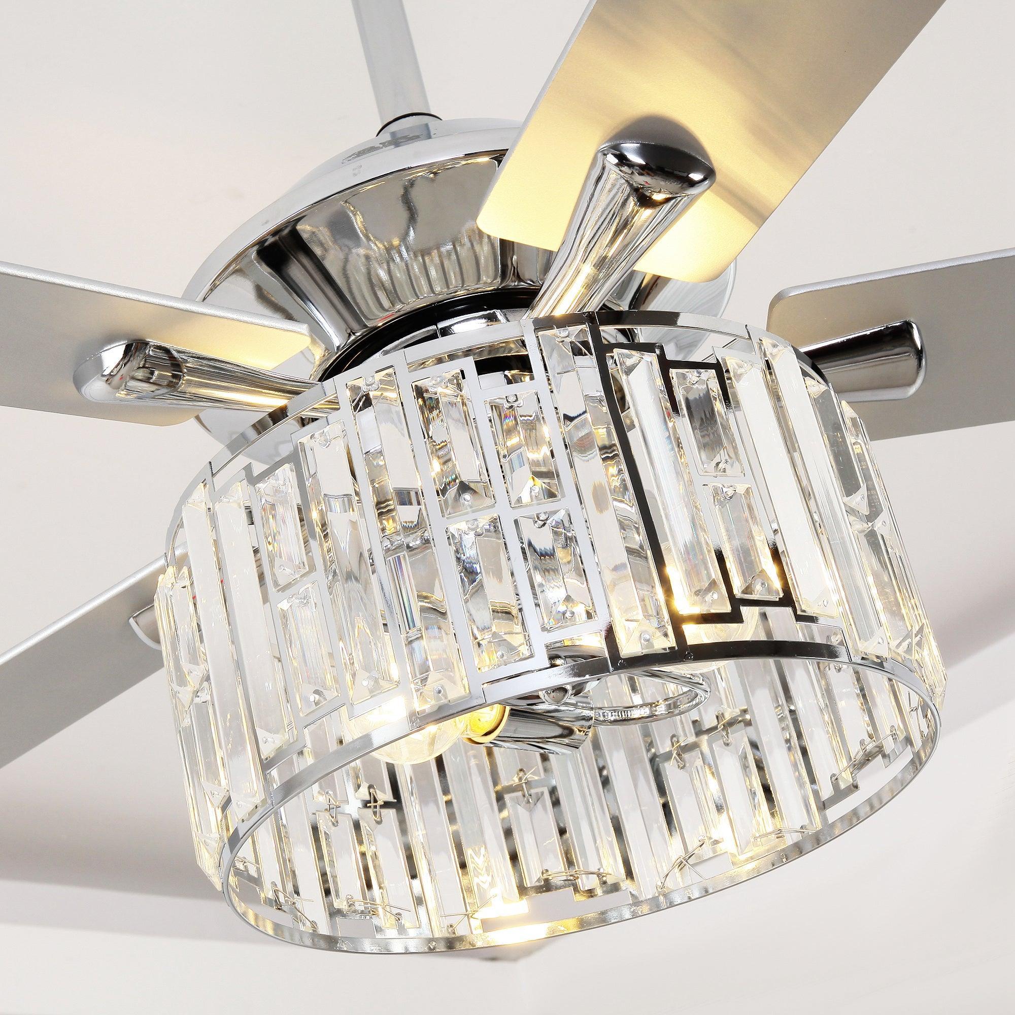 Ceiling fan light with clear crystal shade panels and chrome housing, warm bulbs visible.