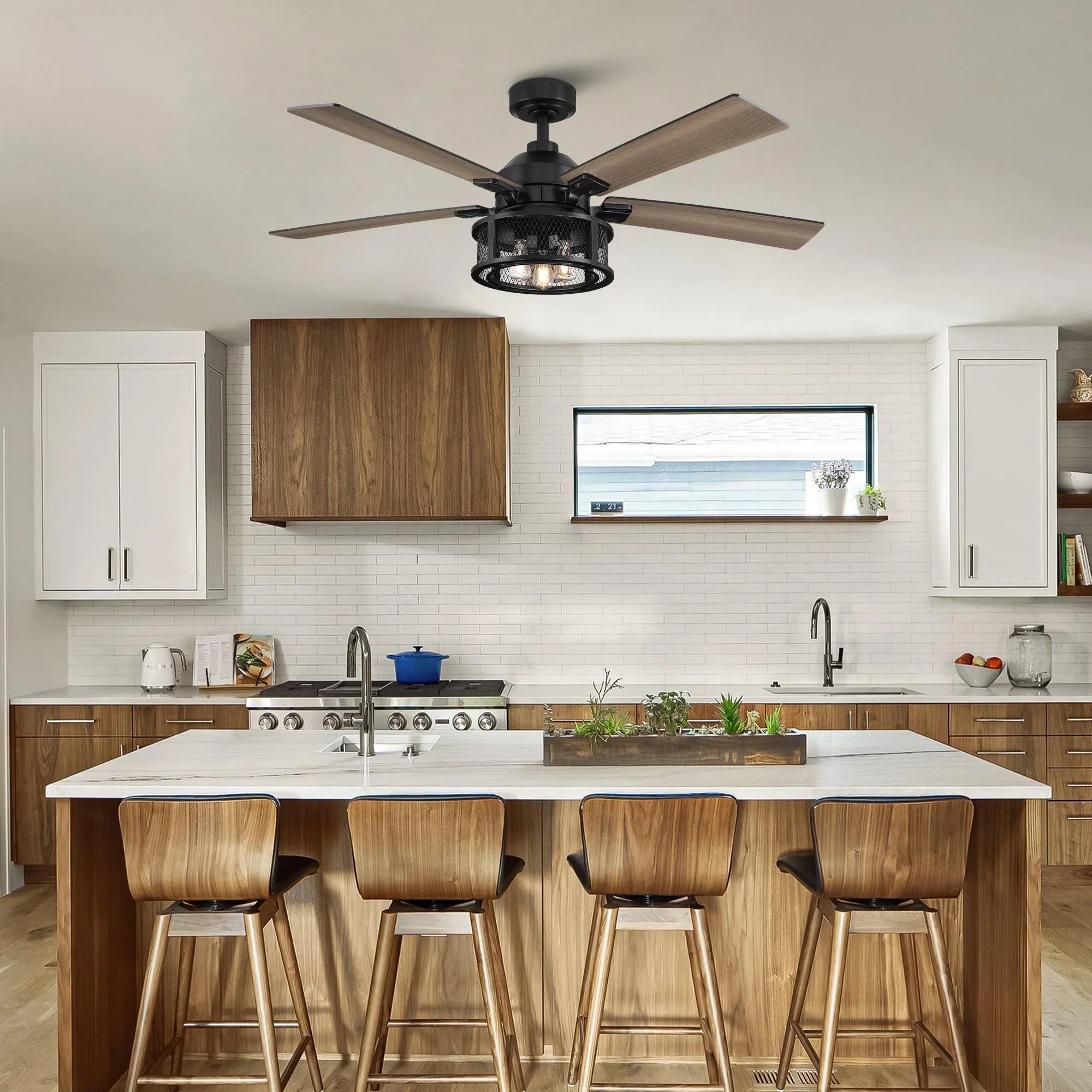 Black ceiling fan with five wood blades and light kit installed above a kitchen counter