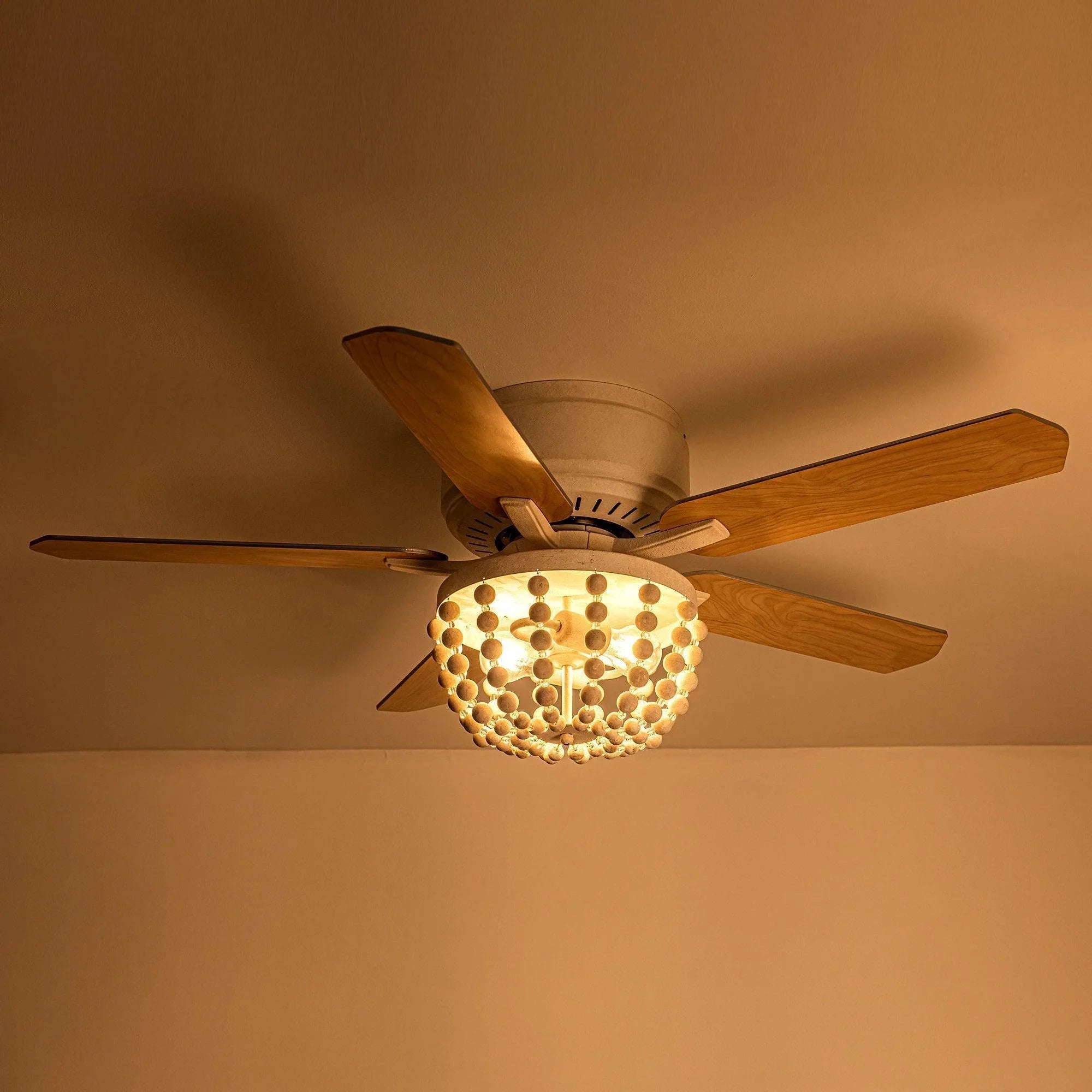 Lit flush mount ceiling fan with wood reversible blades and glowing bead light