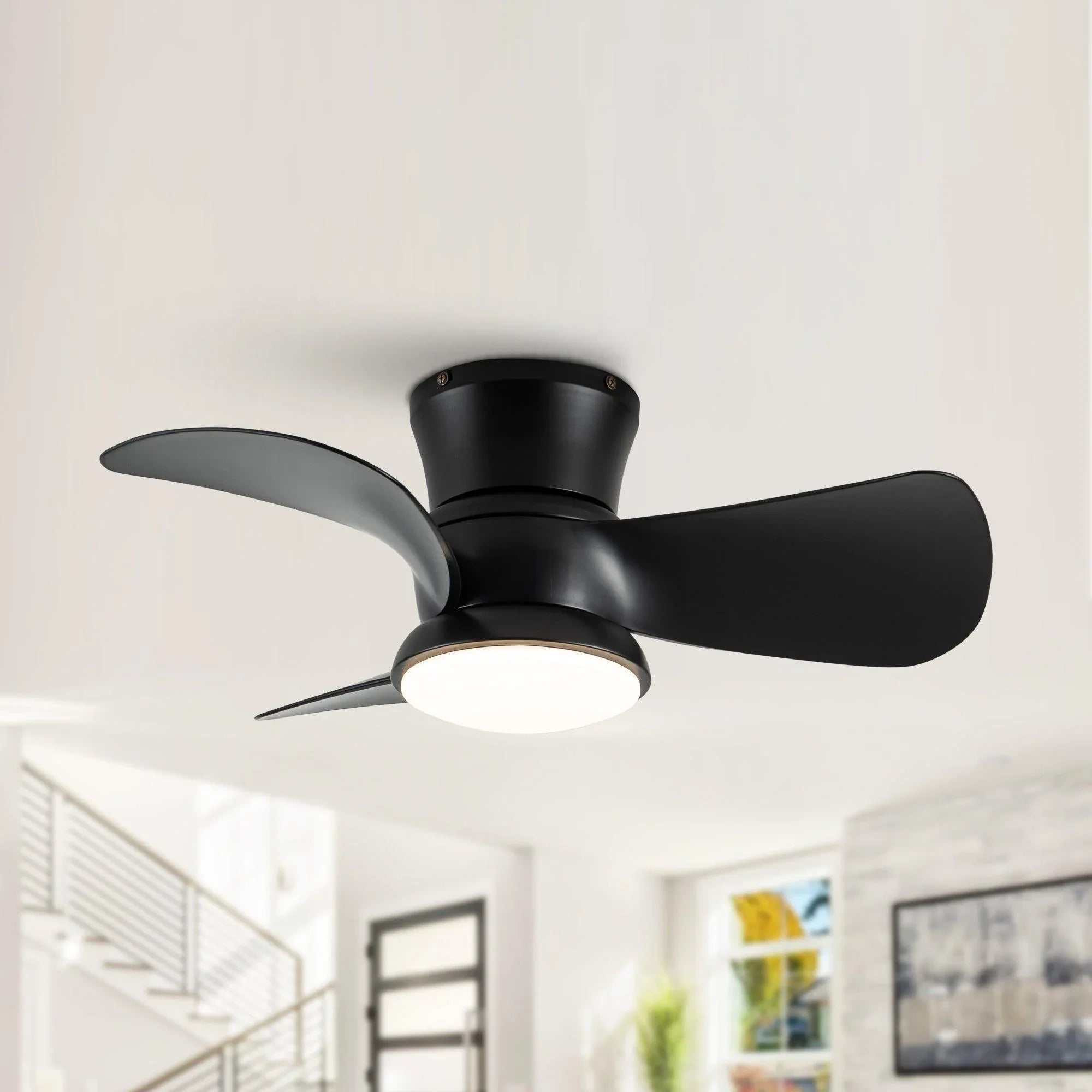 Black flush-mount ceiling fan with three blades and a round integrated light.