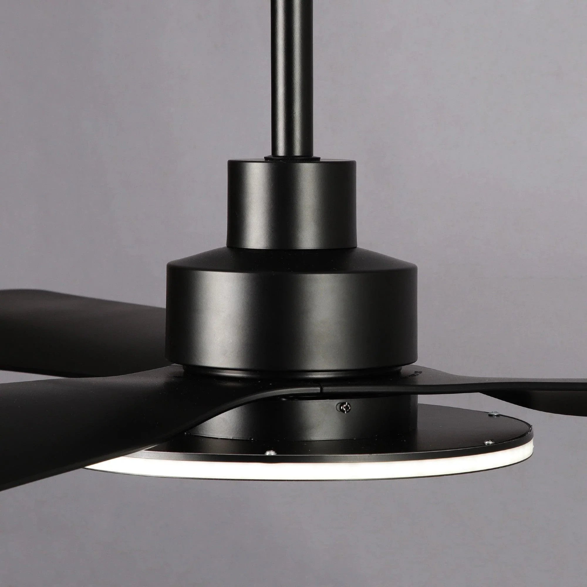 Black ceiling fan with multiple blades and round frosted light diffuser.
