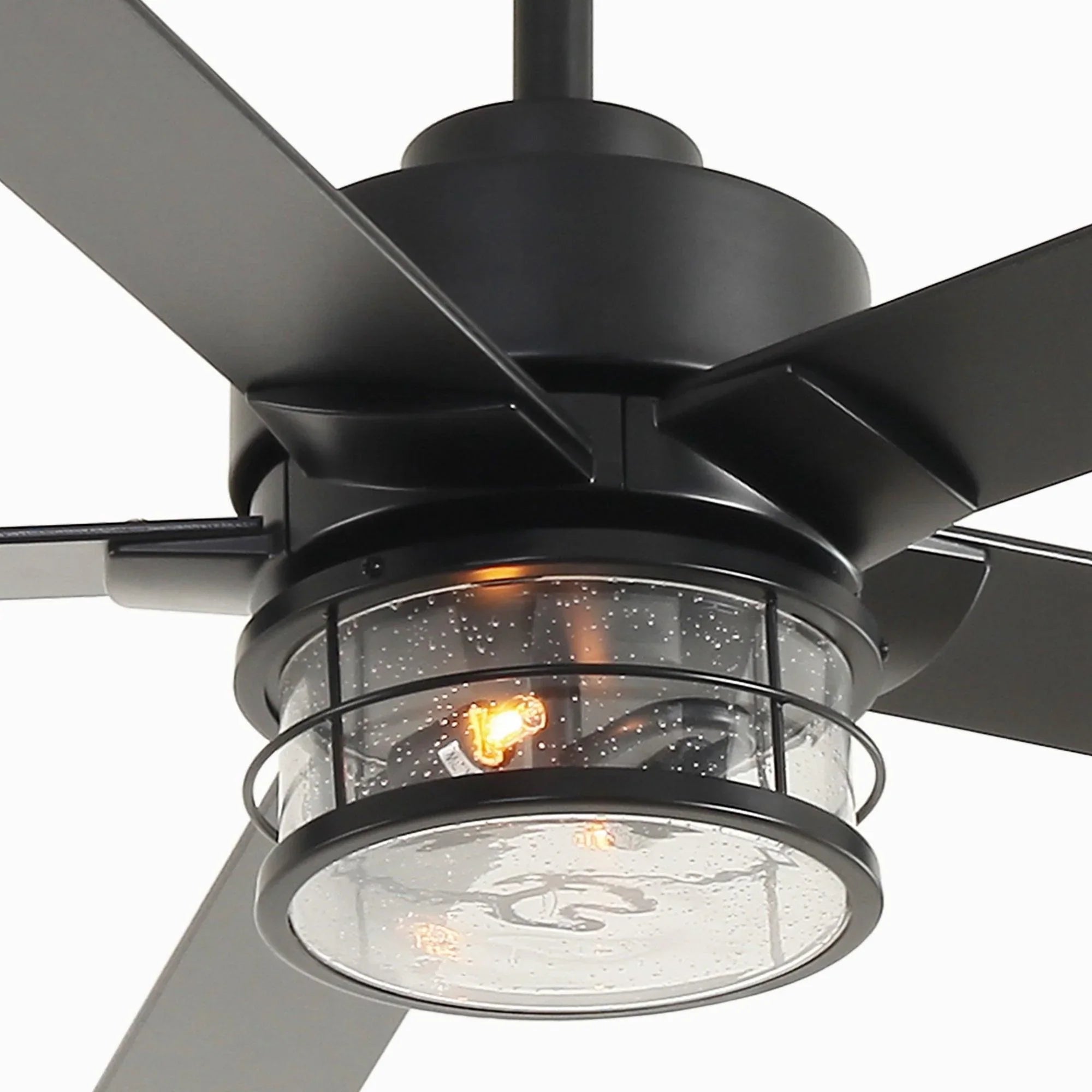 Black ceiling fan light with glass shade and visible warm bulbs