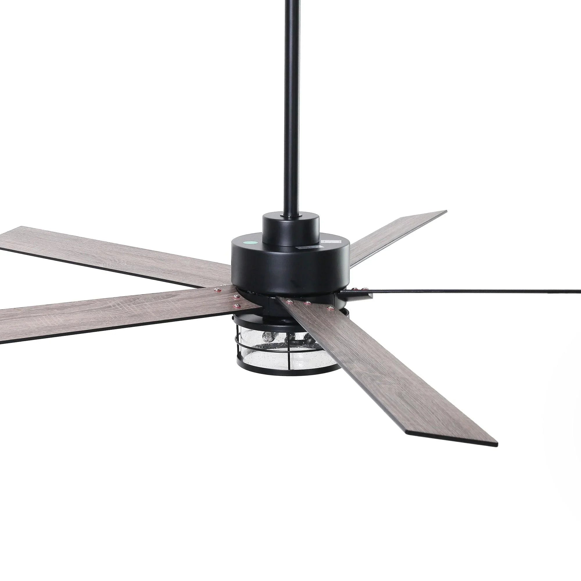 Black ceiling fan with reversible blades showing light wood grain