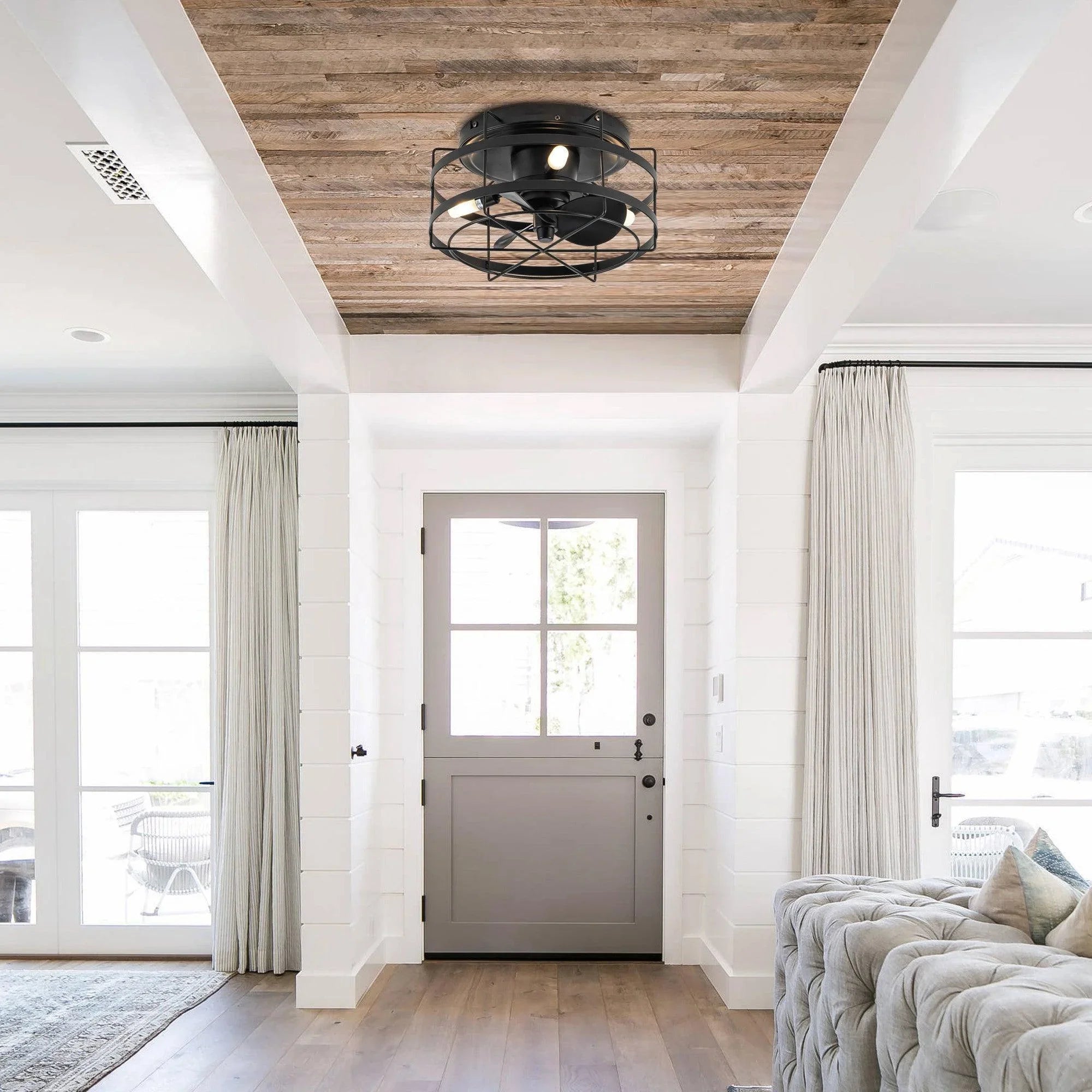Black flush-mount ceiling fan with cage design mounted on high ceiling