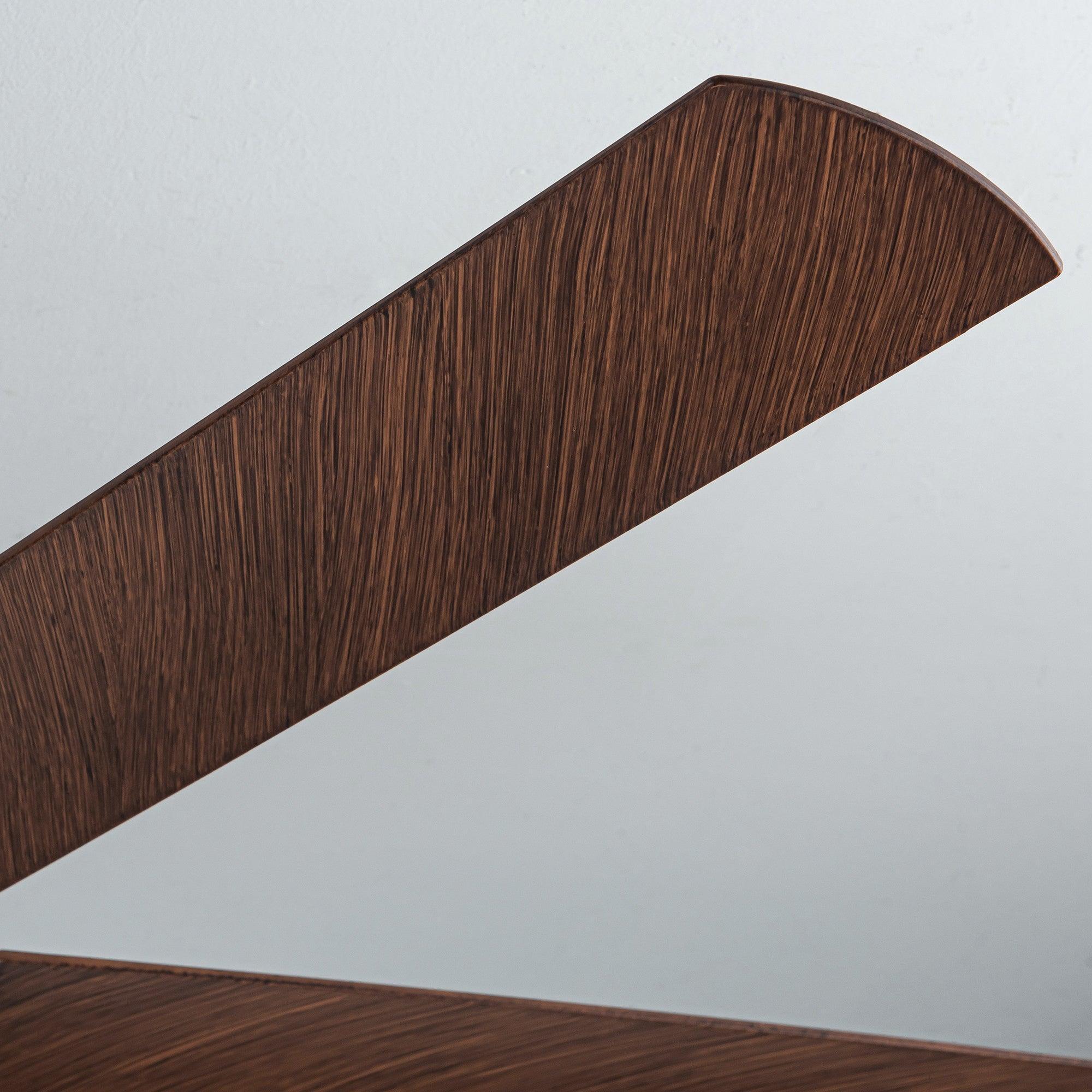 Warm wood ceiling fan blade close-up along the blade edge