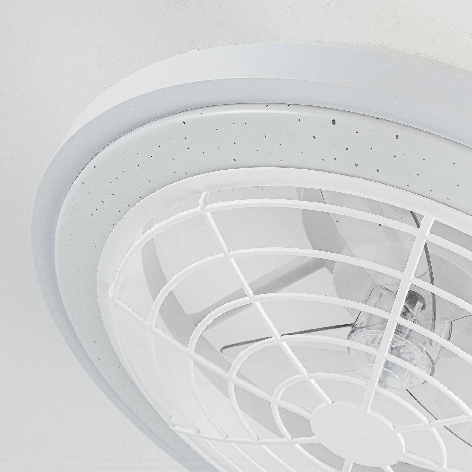 White flush-mount ceiling fan close-up with blade cage and central motor hub