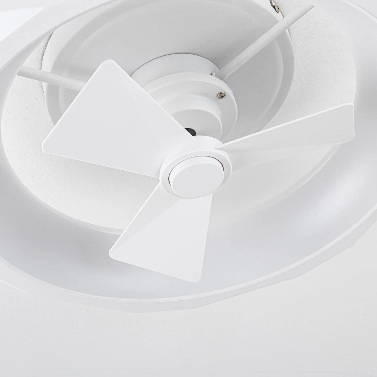 White flush mount ceiling fan close-up with three blades and central motor housing