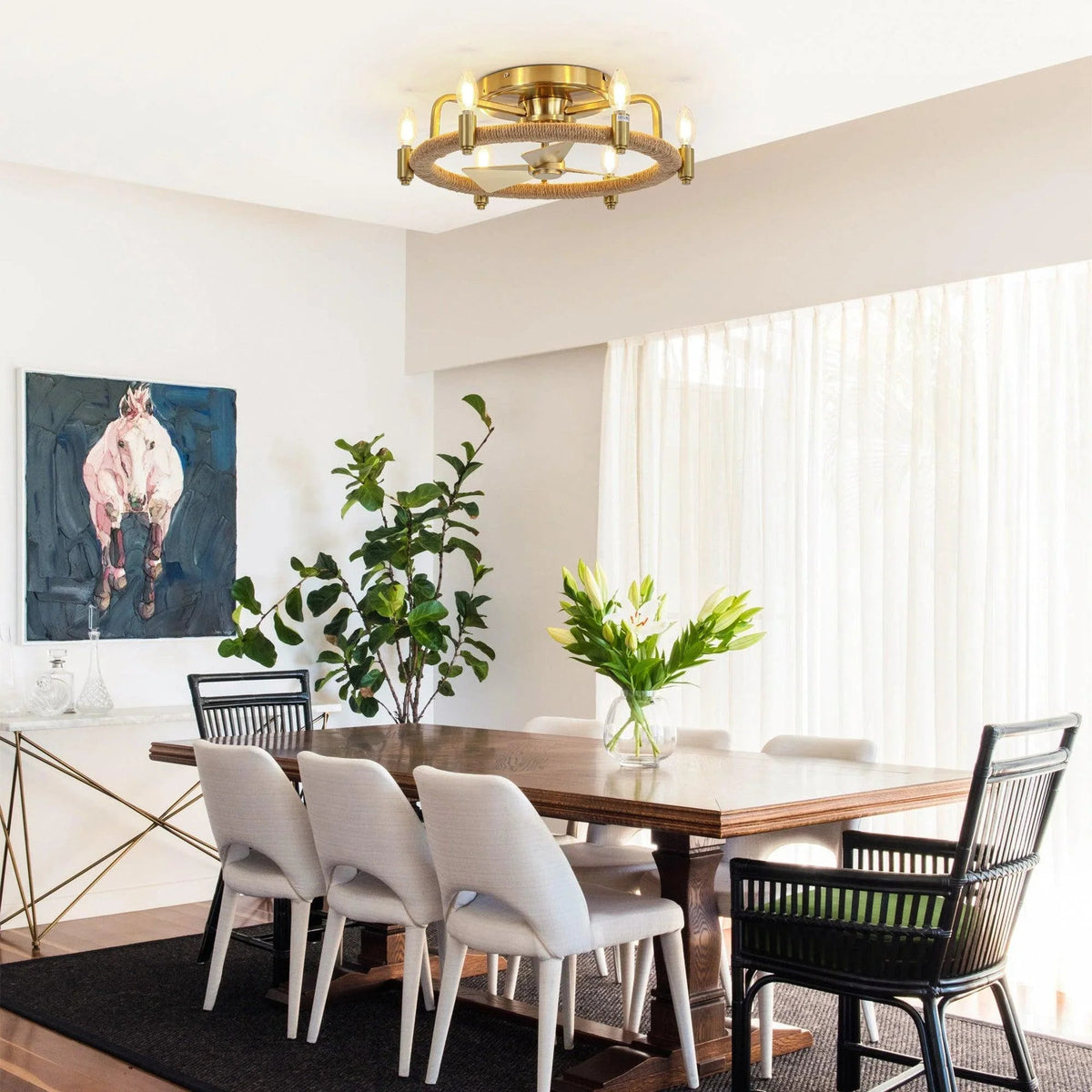 Golden flush mount ceiling fan with light above dining area, rope-wrapped ring and bulbs
