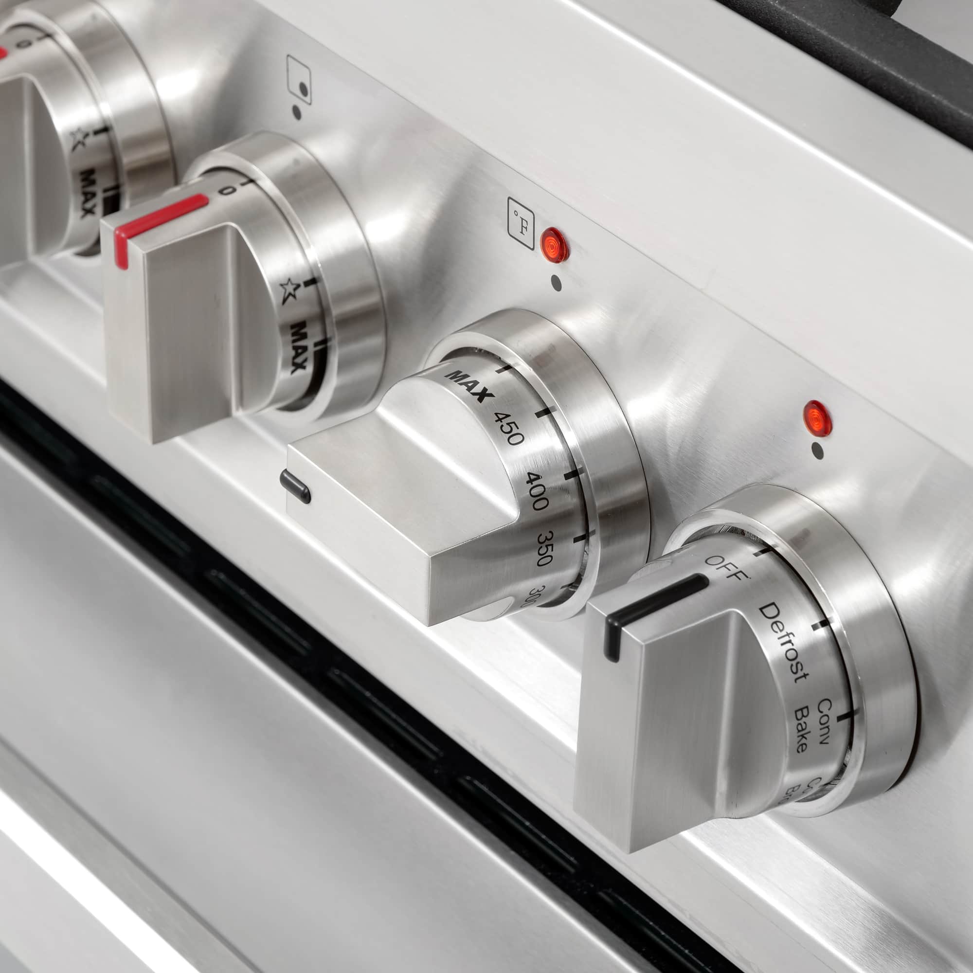 Stainless steel oven and burner control knobs with red indicator marks