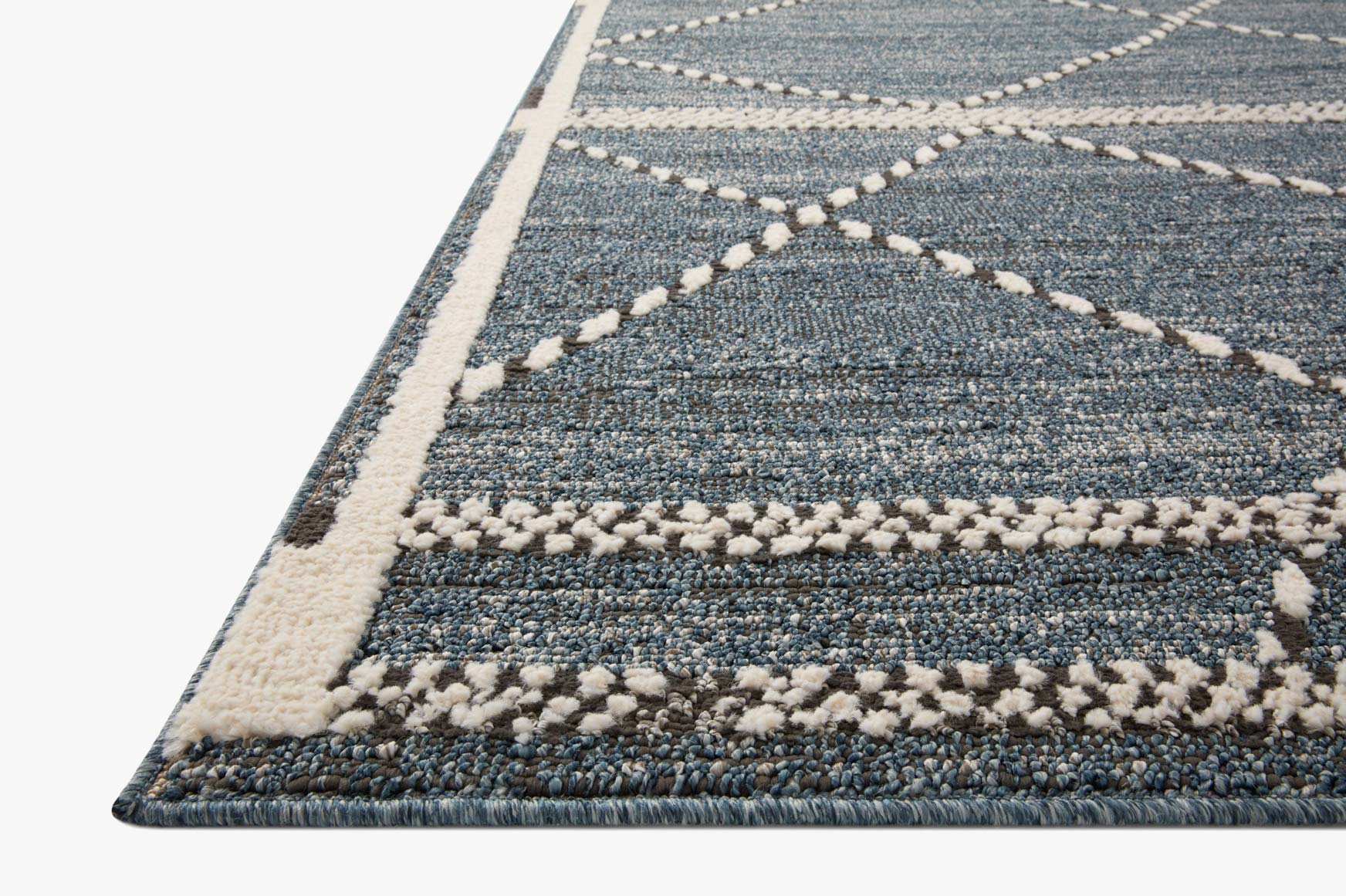 Denim-blue area rug with cream border, textured flatweave and geometric diamond pattern