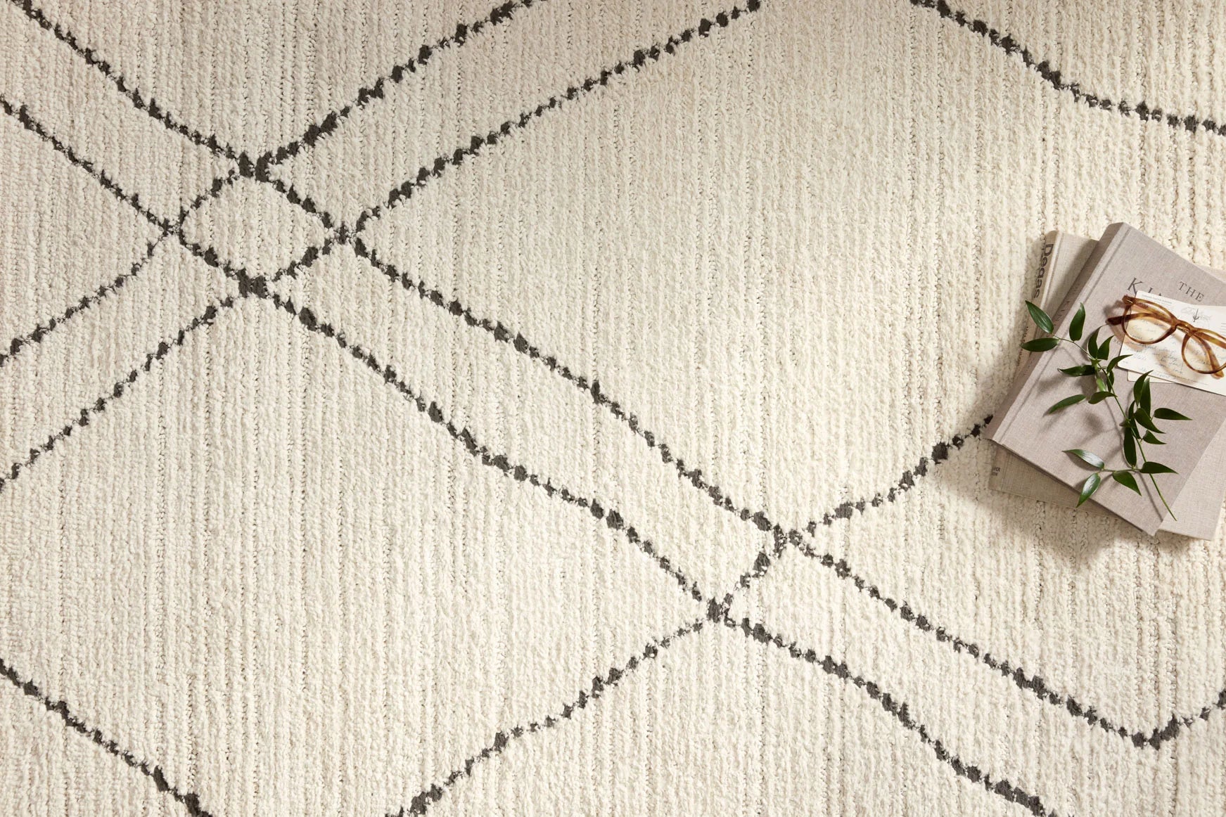 Ivory rug with charcoal outlined diamond lattice, textured low pile