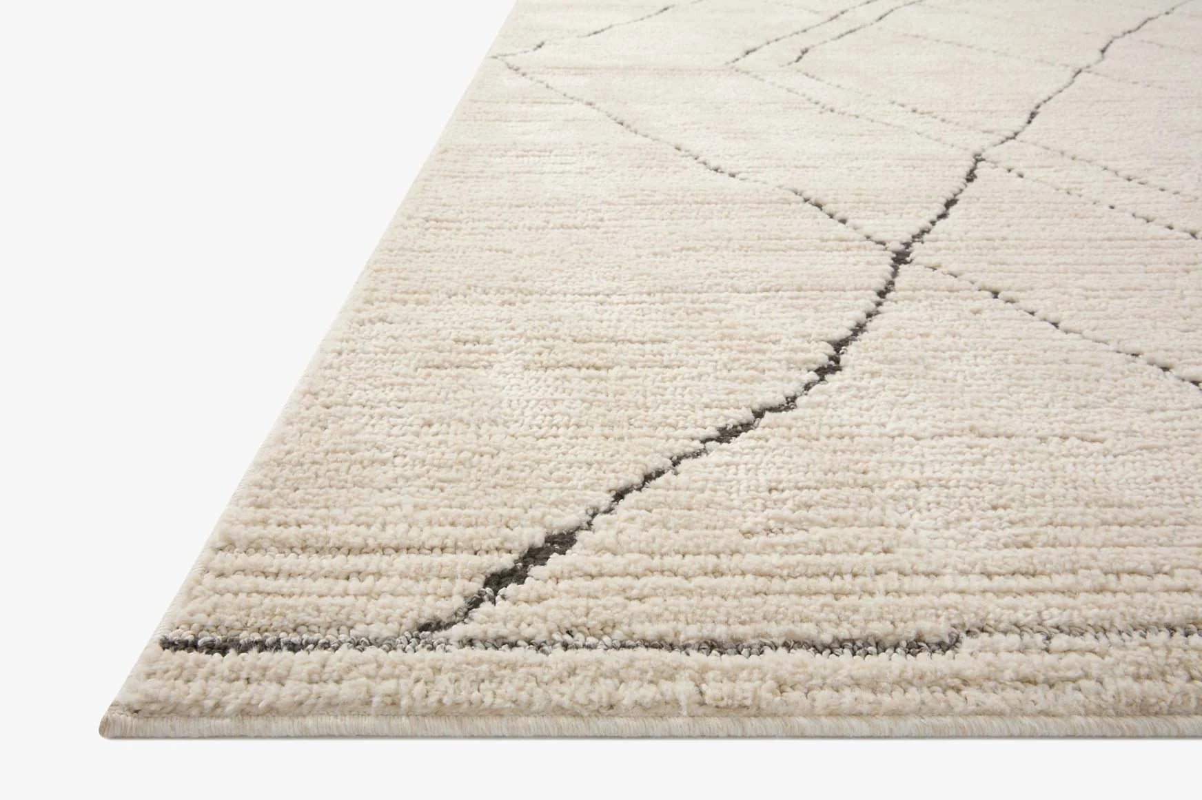 Ivory area rug with charcoal diamond lattice pattern and short textured pile
