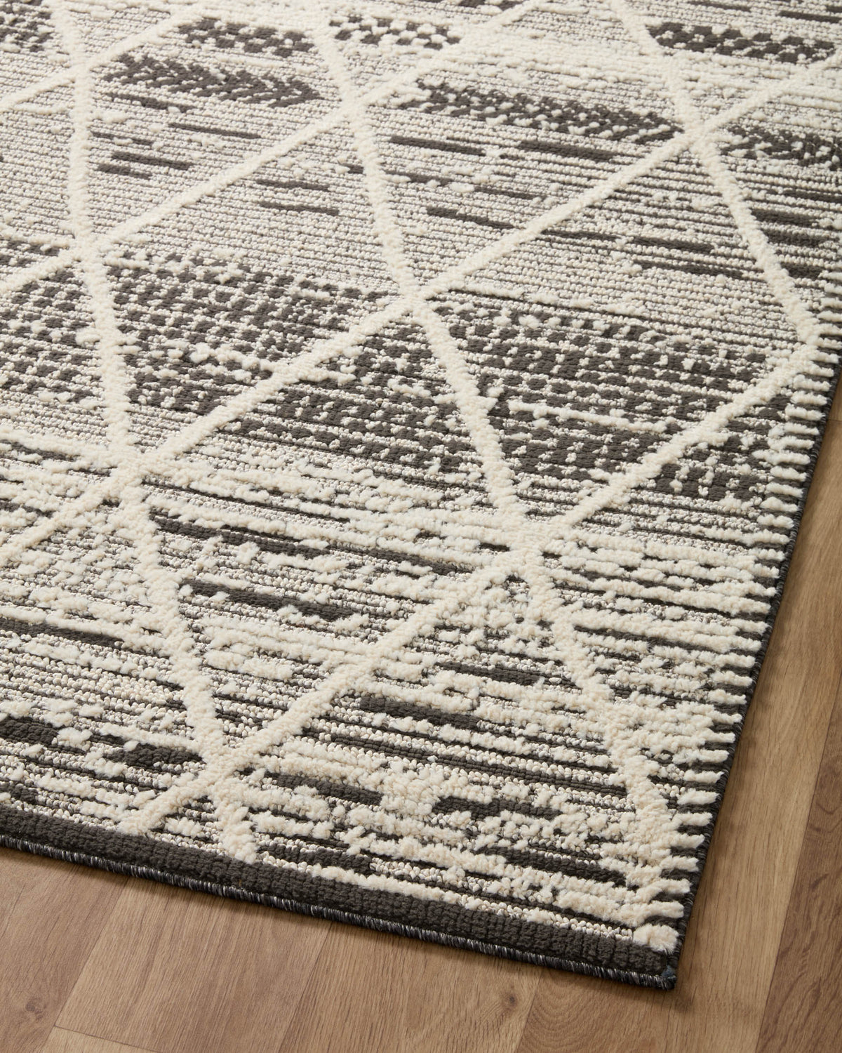 Charcoal and ivory geometric area rug with lattice and block pattern