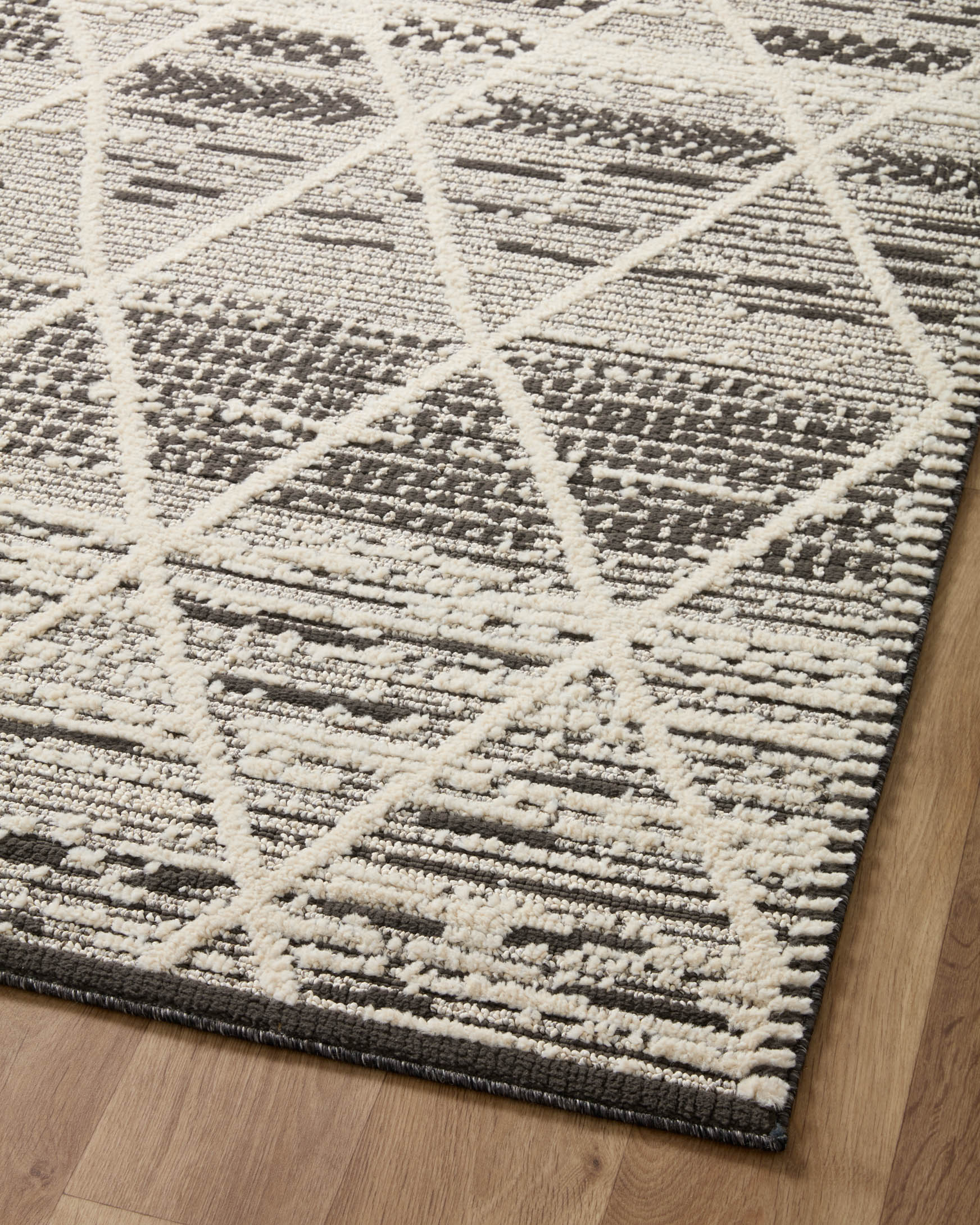 Charcoal and ivory runner rug with diamond and stripe geometric pattern