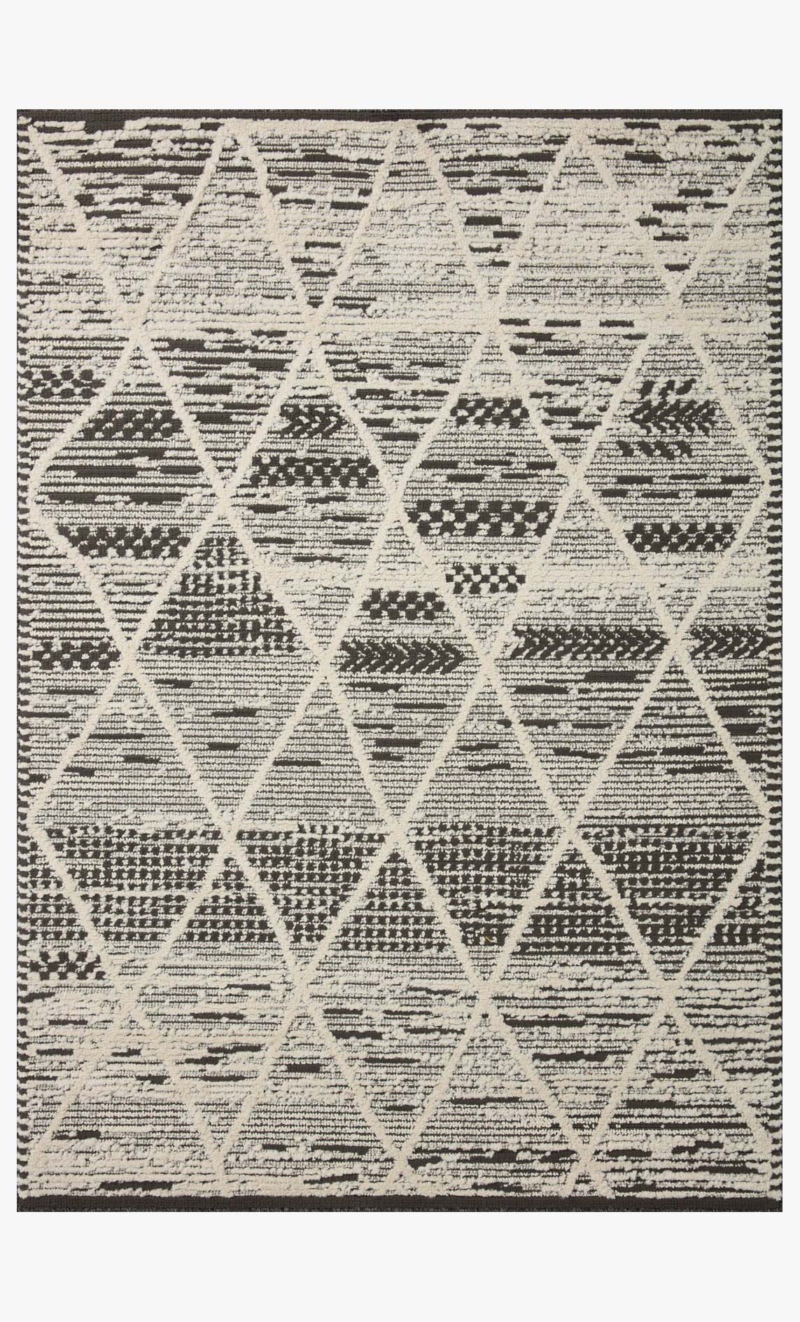 Charcoal and ivory patterned area rug with large repeating X and triangle motifs