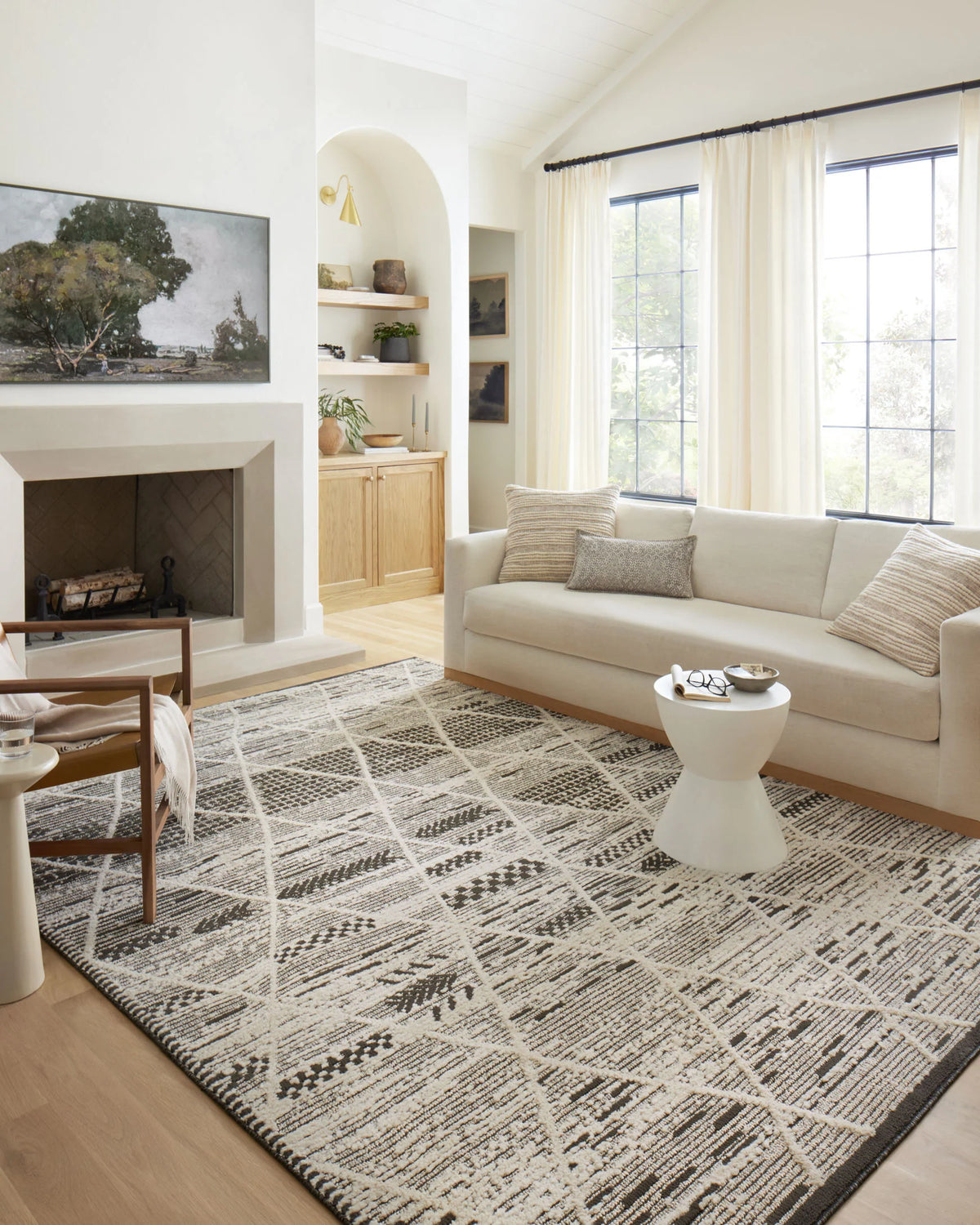 Ivory and charcoal area rug with distressed geometric lines and corner fringe