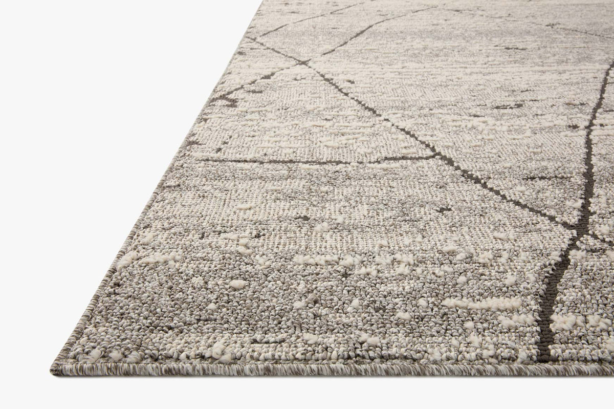 Distressed geometric runner rug in light grey with dark charcoal linework and fringed edge