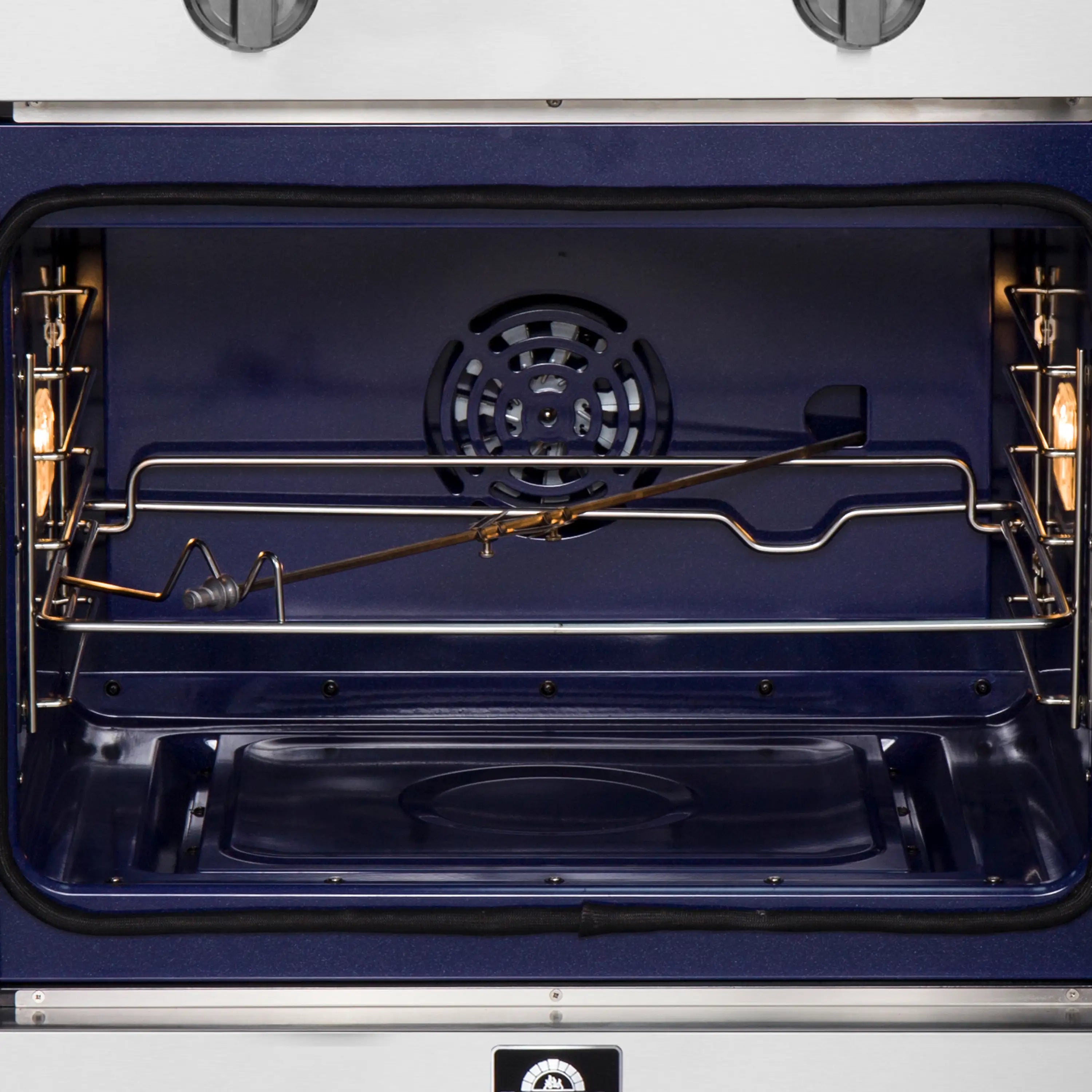 Interior oven cavity with fan vent, upper heating elements, and back-wire rack