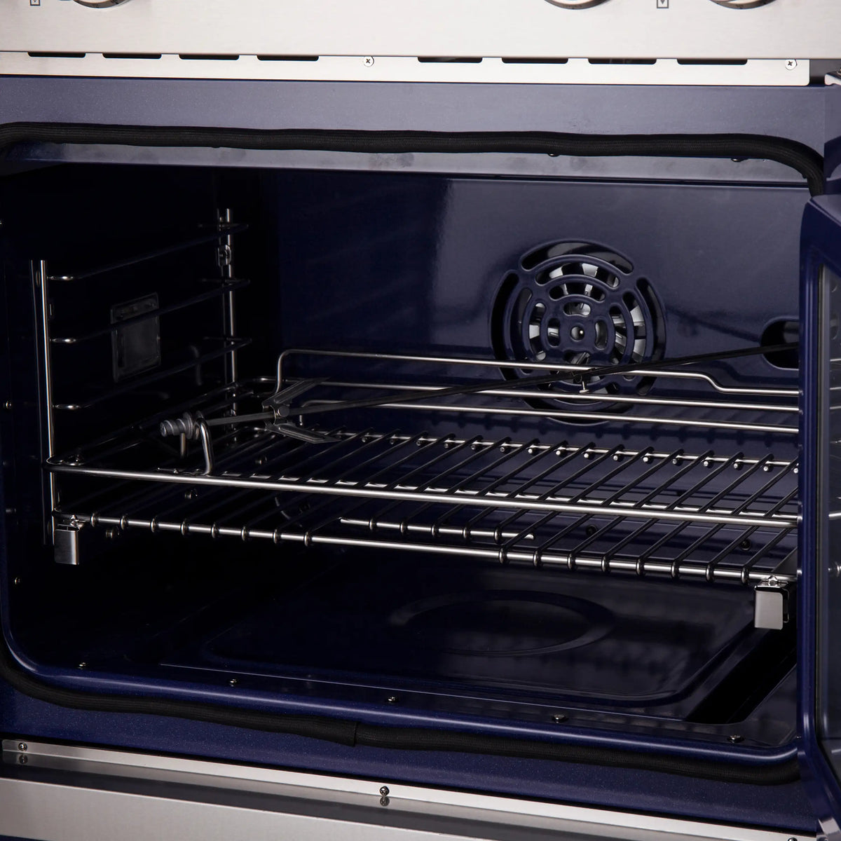 Open oven cavity with fan at the back and multiple racks inside the electric double oven