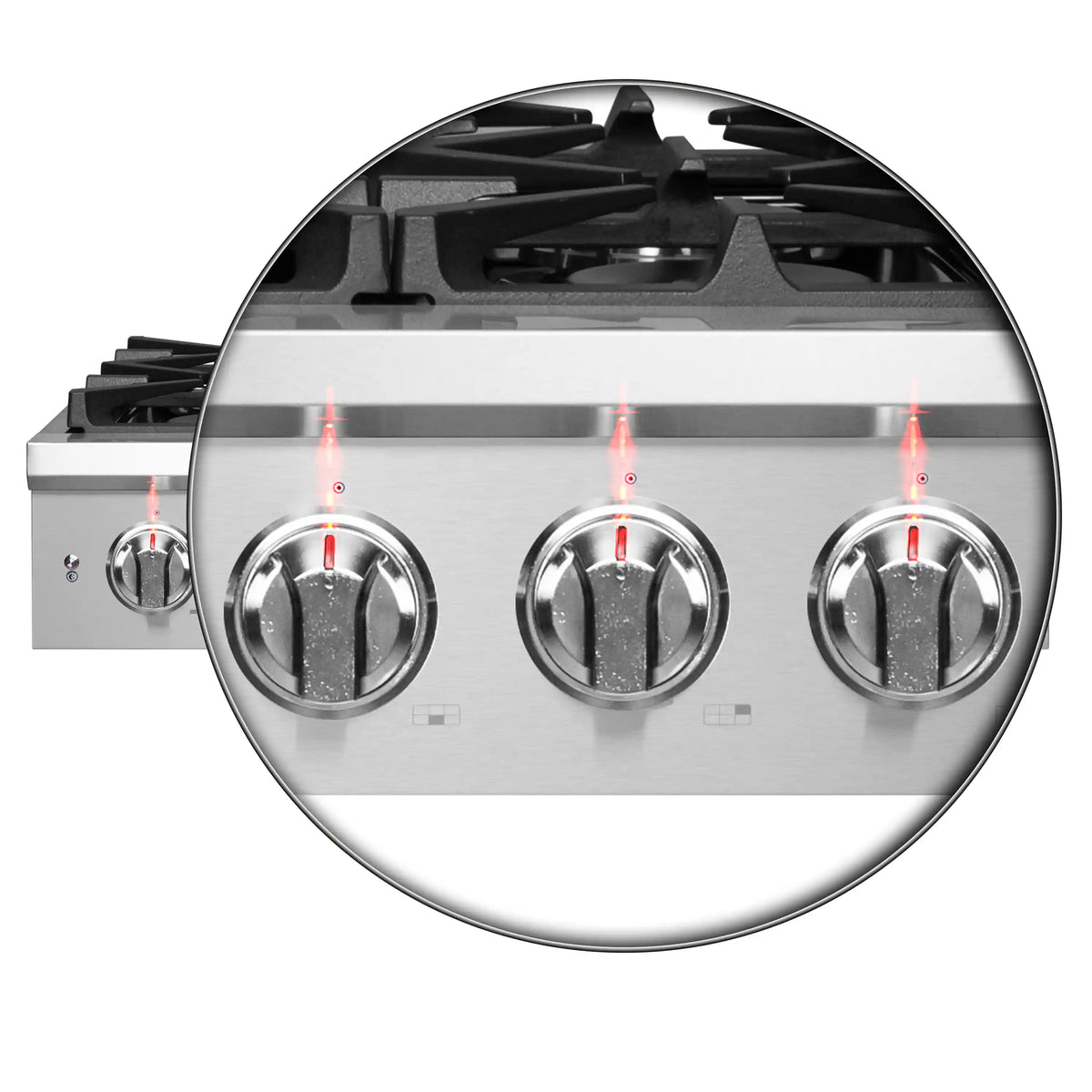 Close-up of stainless gas burner control knobs with igniters, top view
