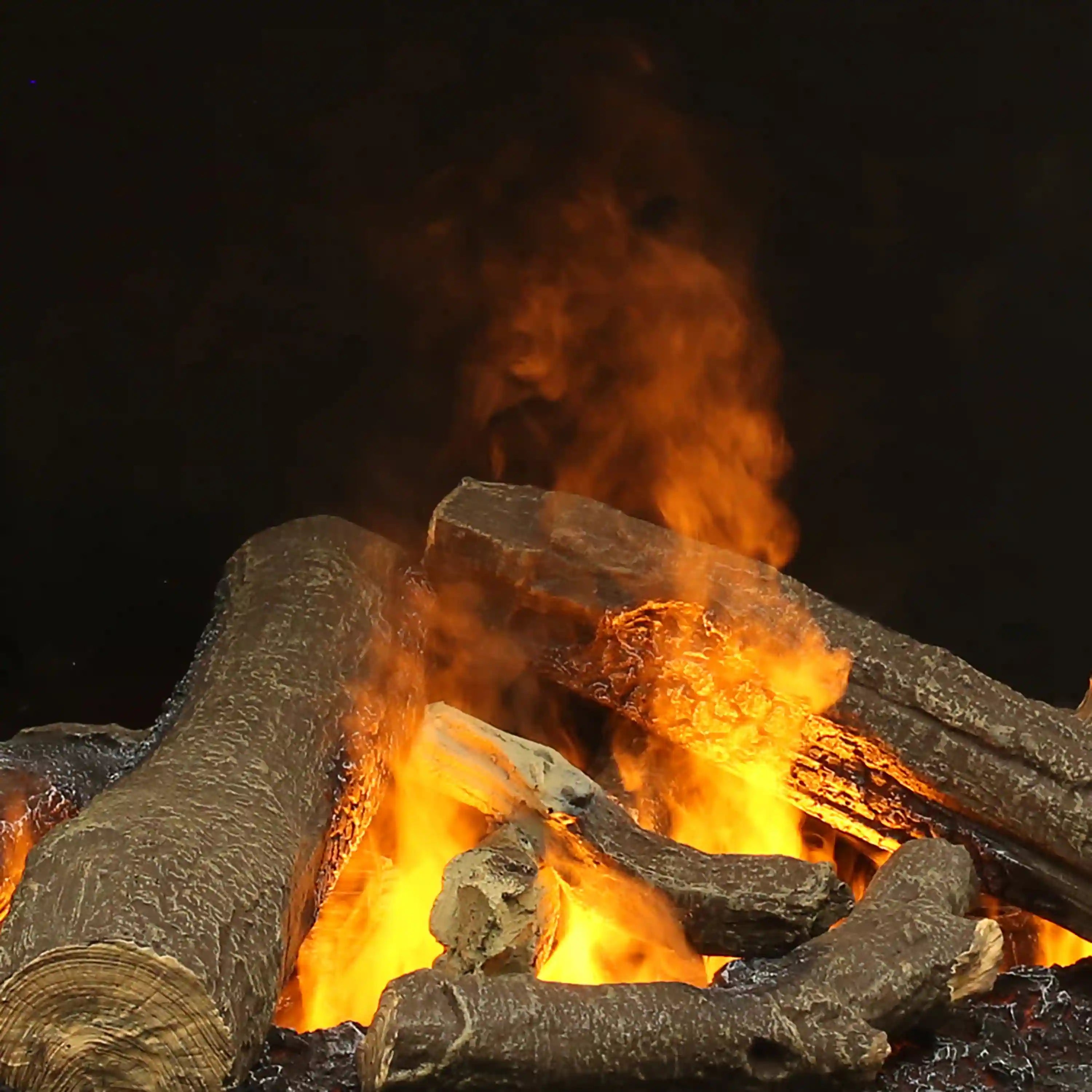 Electric firebox with faux logs and glowing flame effect inside a dark fire bed