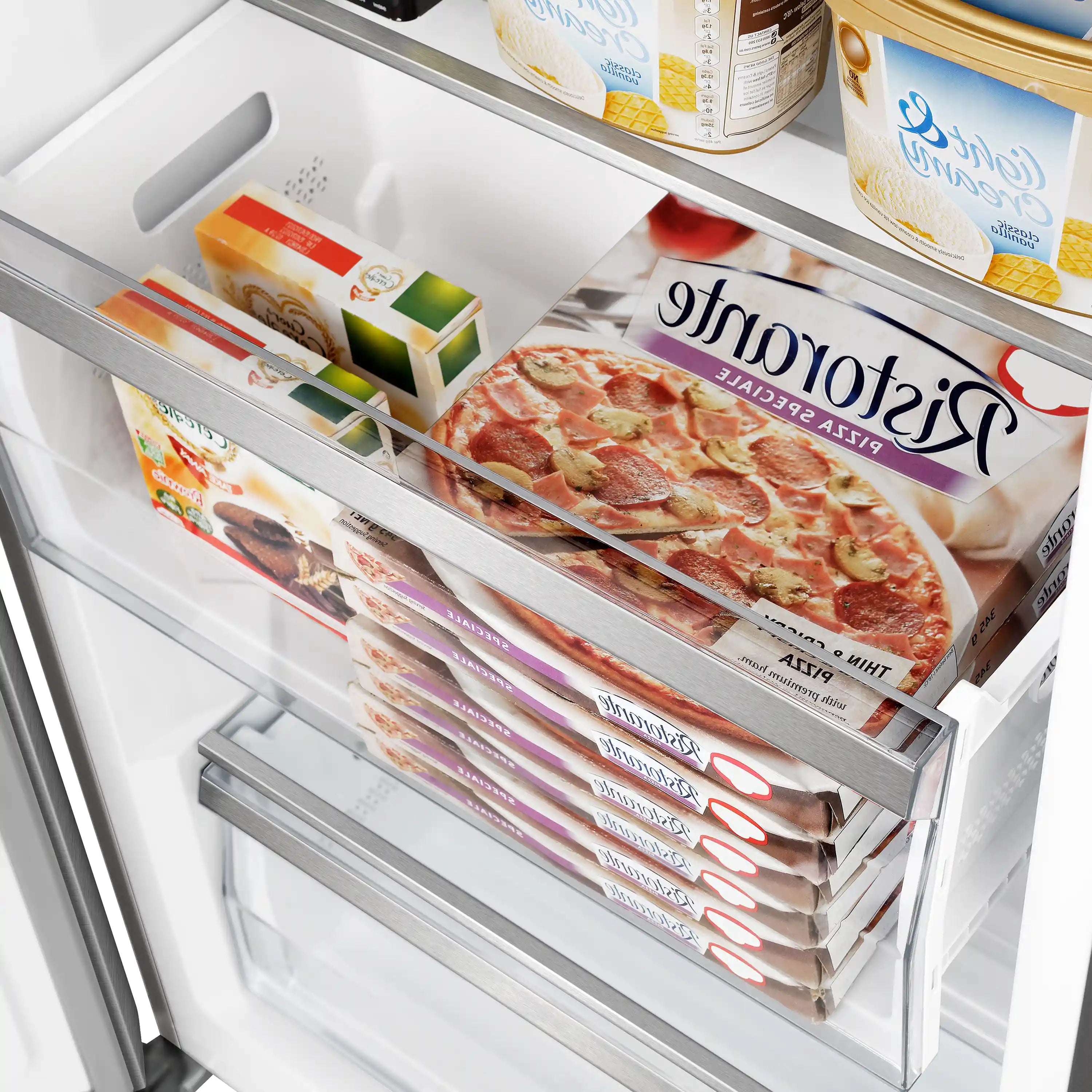 Freezer drawer with frozen meal packages and sealed food items stacked inside