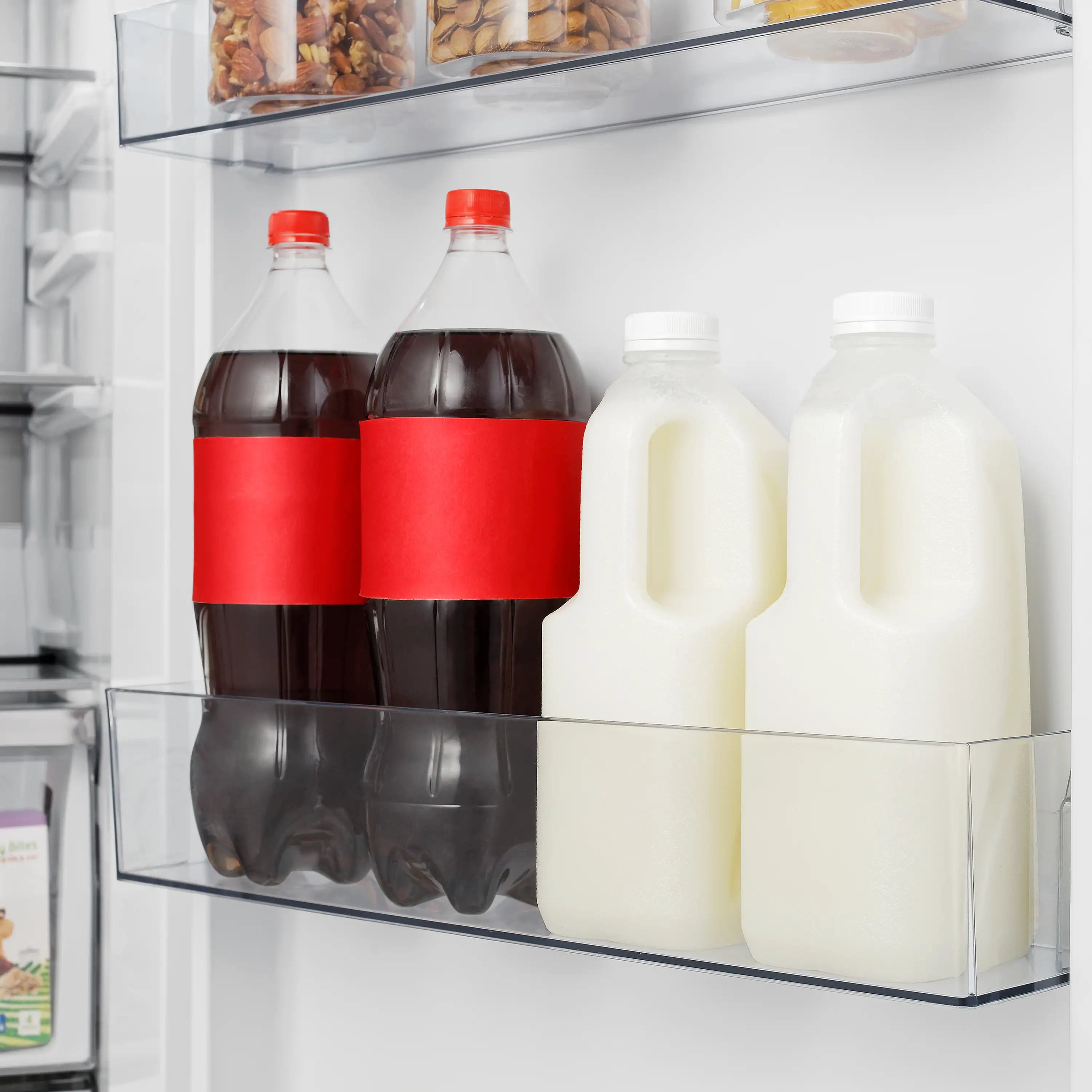 Refrigerator interior shelf with milk bottles and juice containers