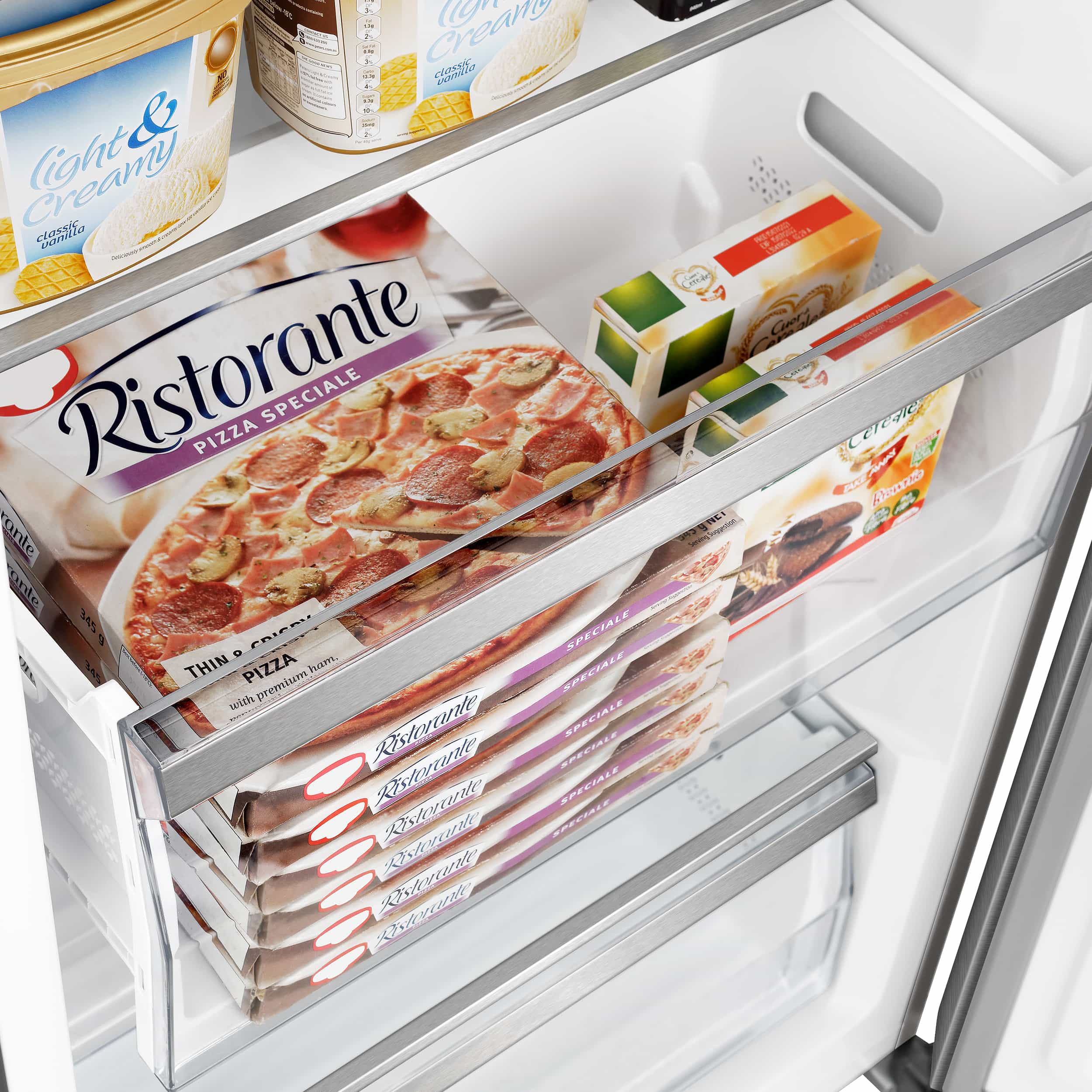 Refrigerator shelf with stacked frozen pizza boxes