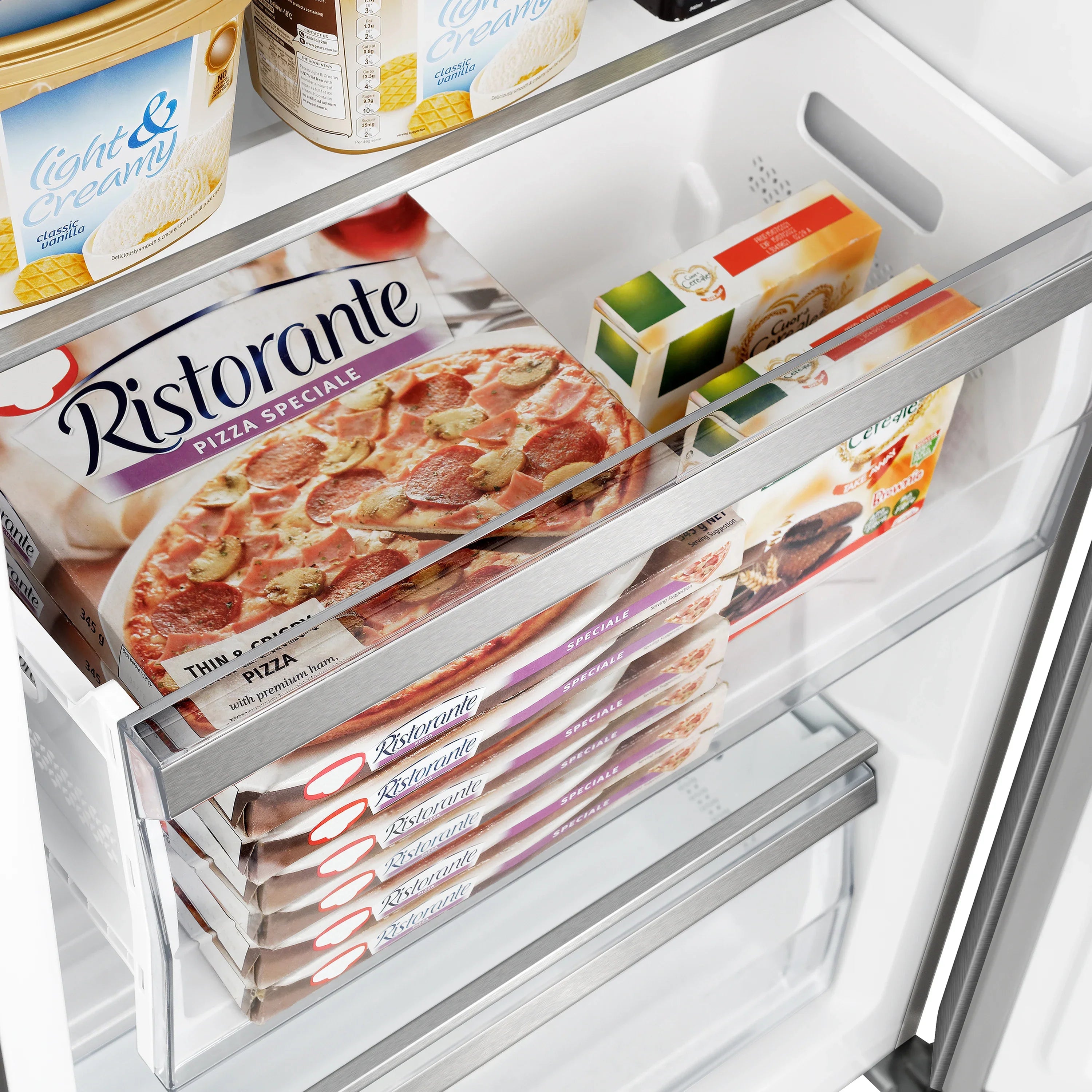Refrigerator freezer drawer stocked with frozen pizza packages.