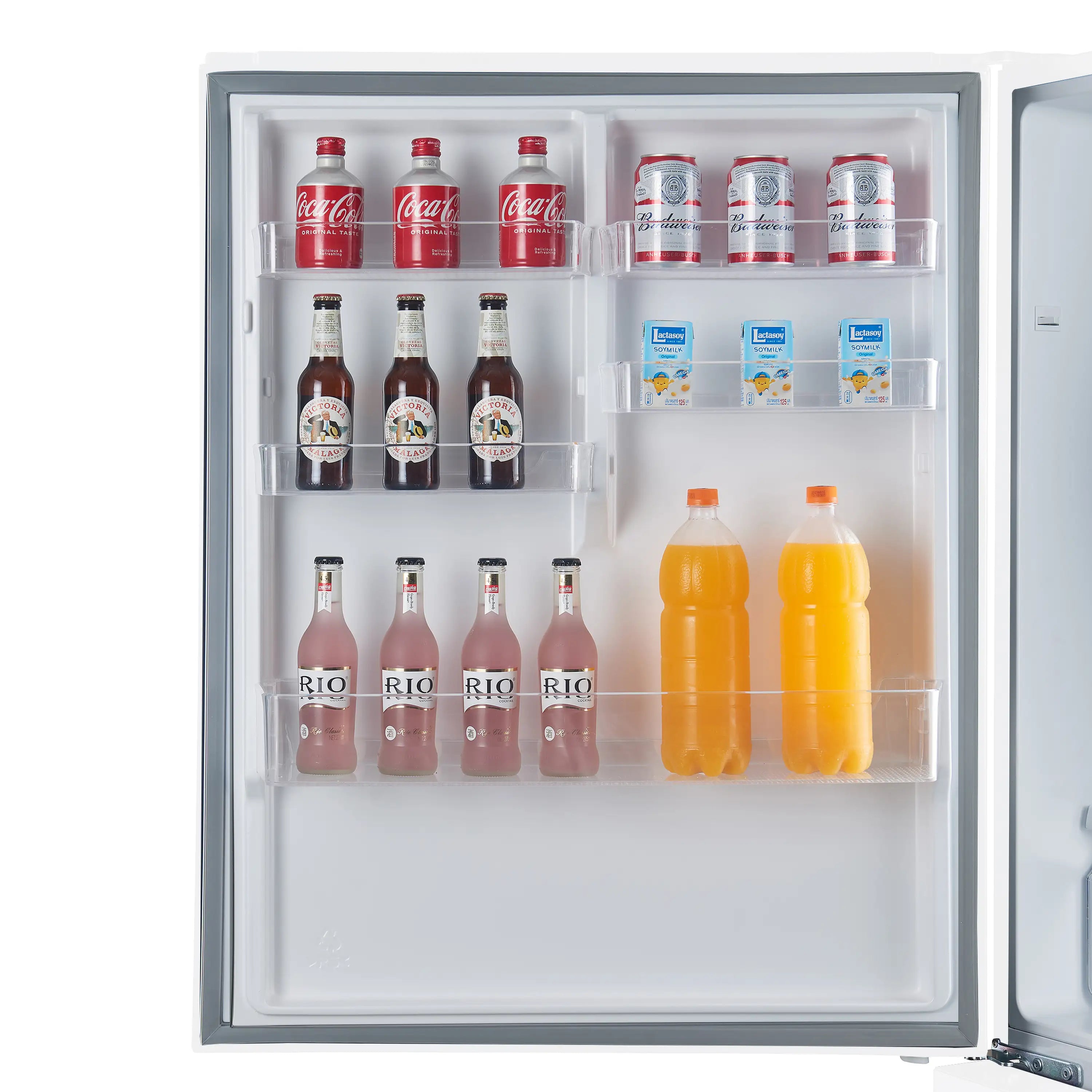 Refrigerator interior with bottles, cartons, and fruit on storage shelves