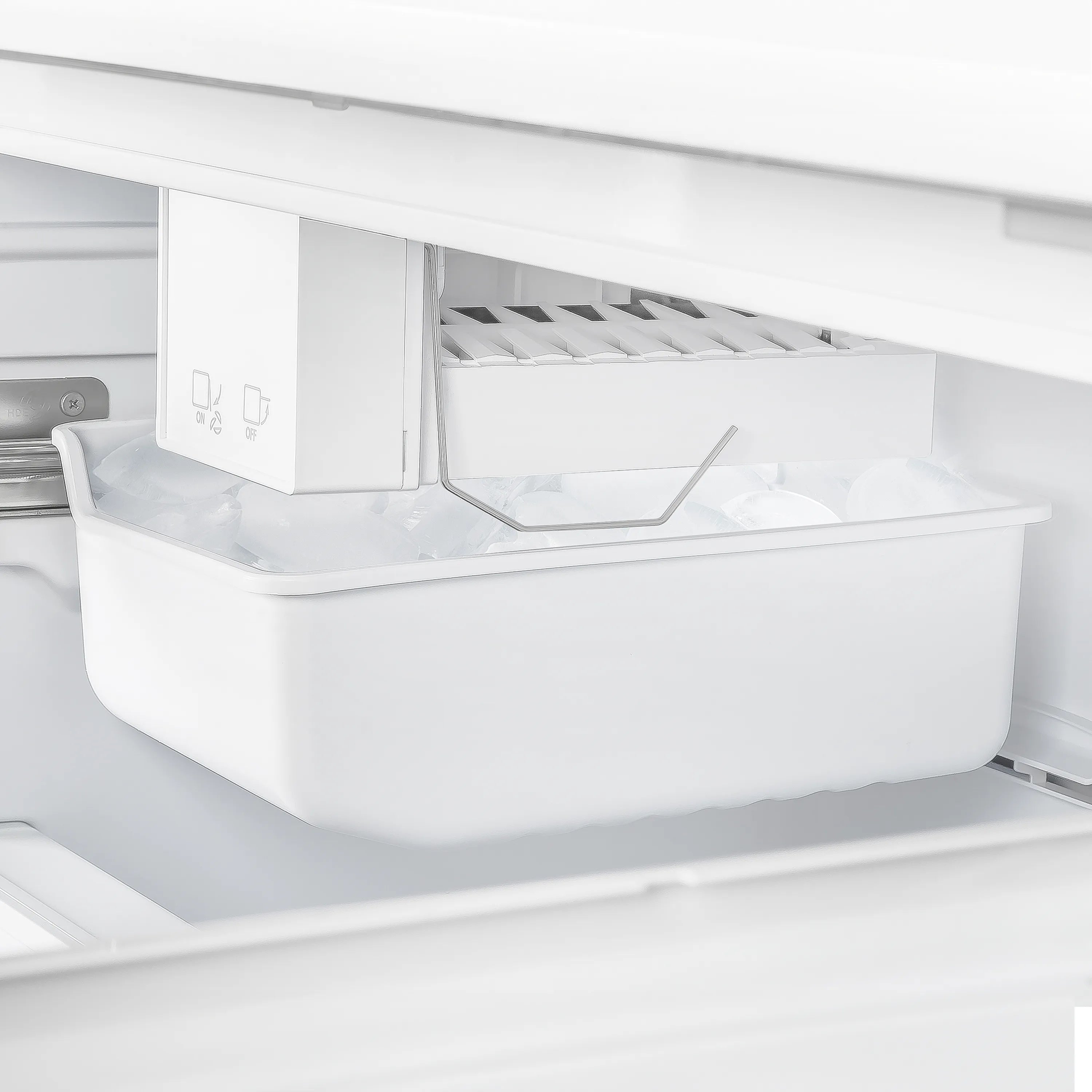 Refrigerator ice maker bin with ice tray inside freezer compartment