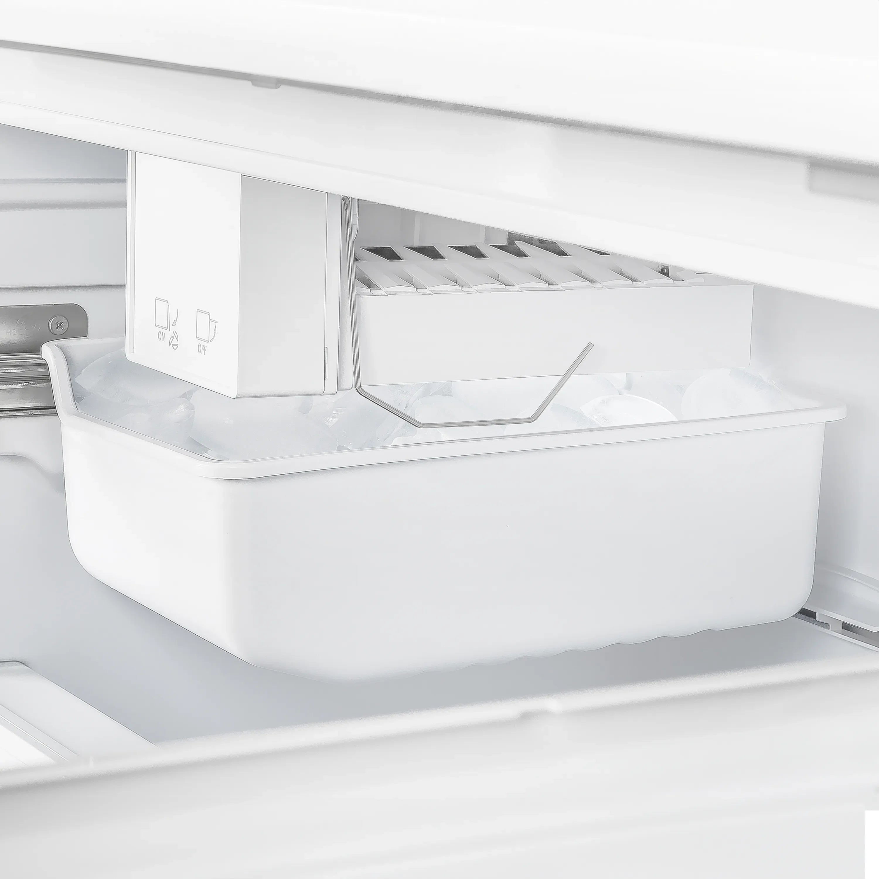 White freezer bin and ice storage compartment with internal ice maker housing.