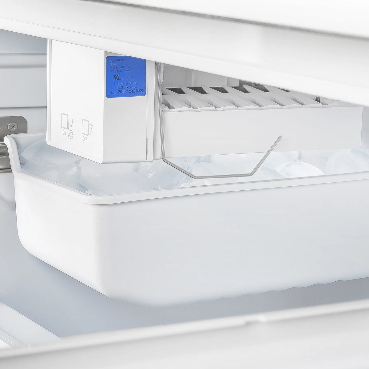 Ice maker area with cover and interior chute inside freezer