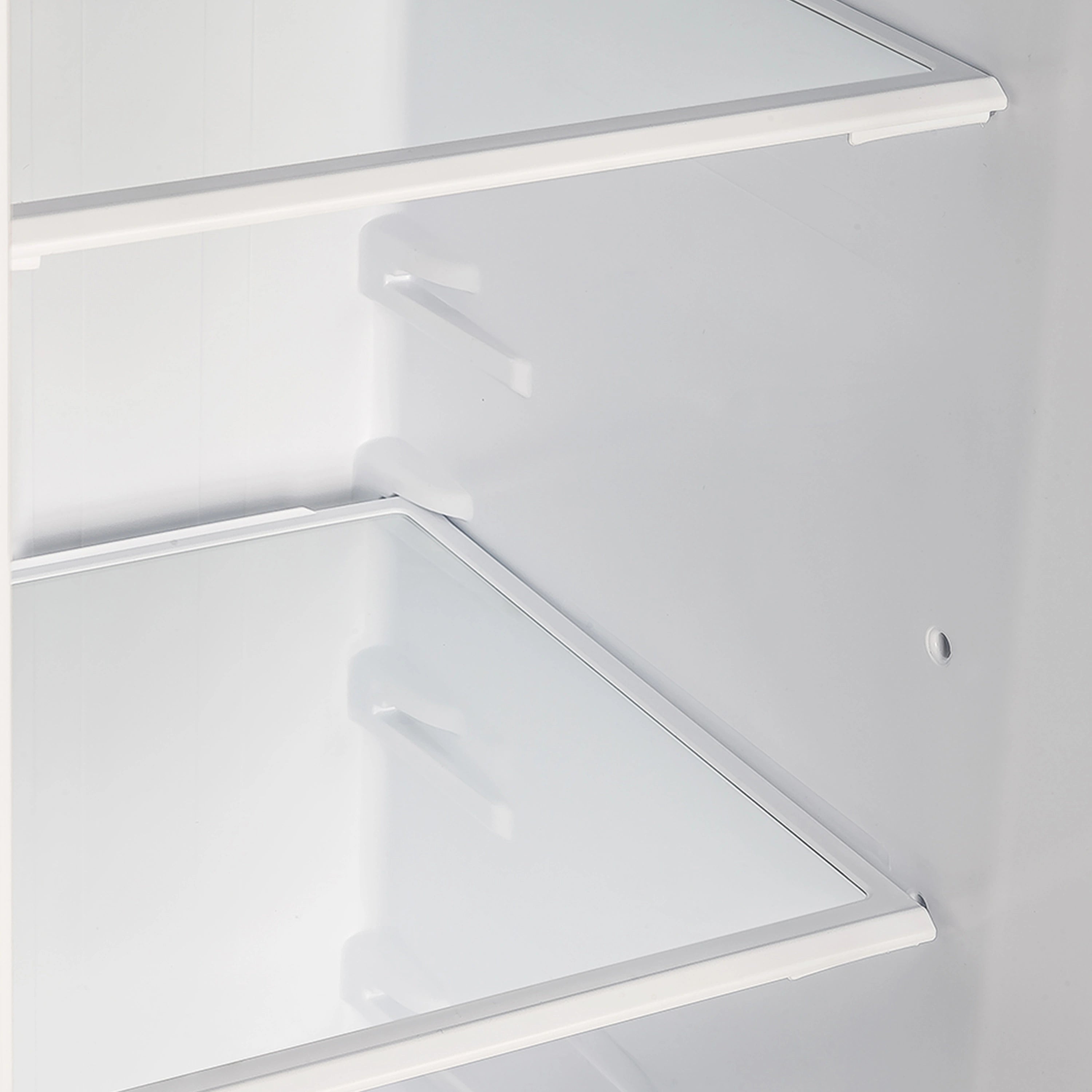Side-by-side refrigerator interior with white shelves and door bin