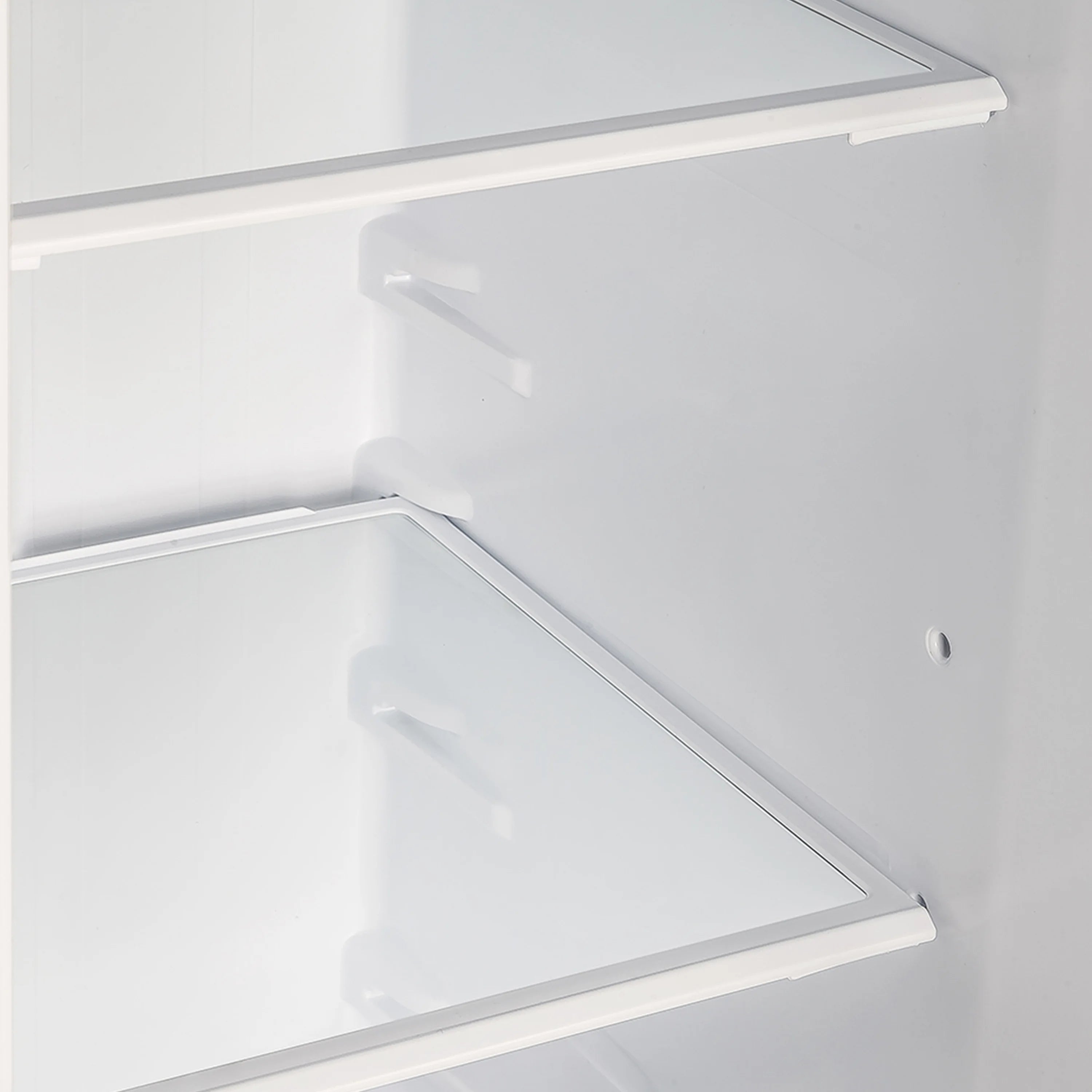 Freezer compartment with white shelving, door panel, and interior vent area