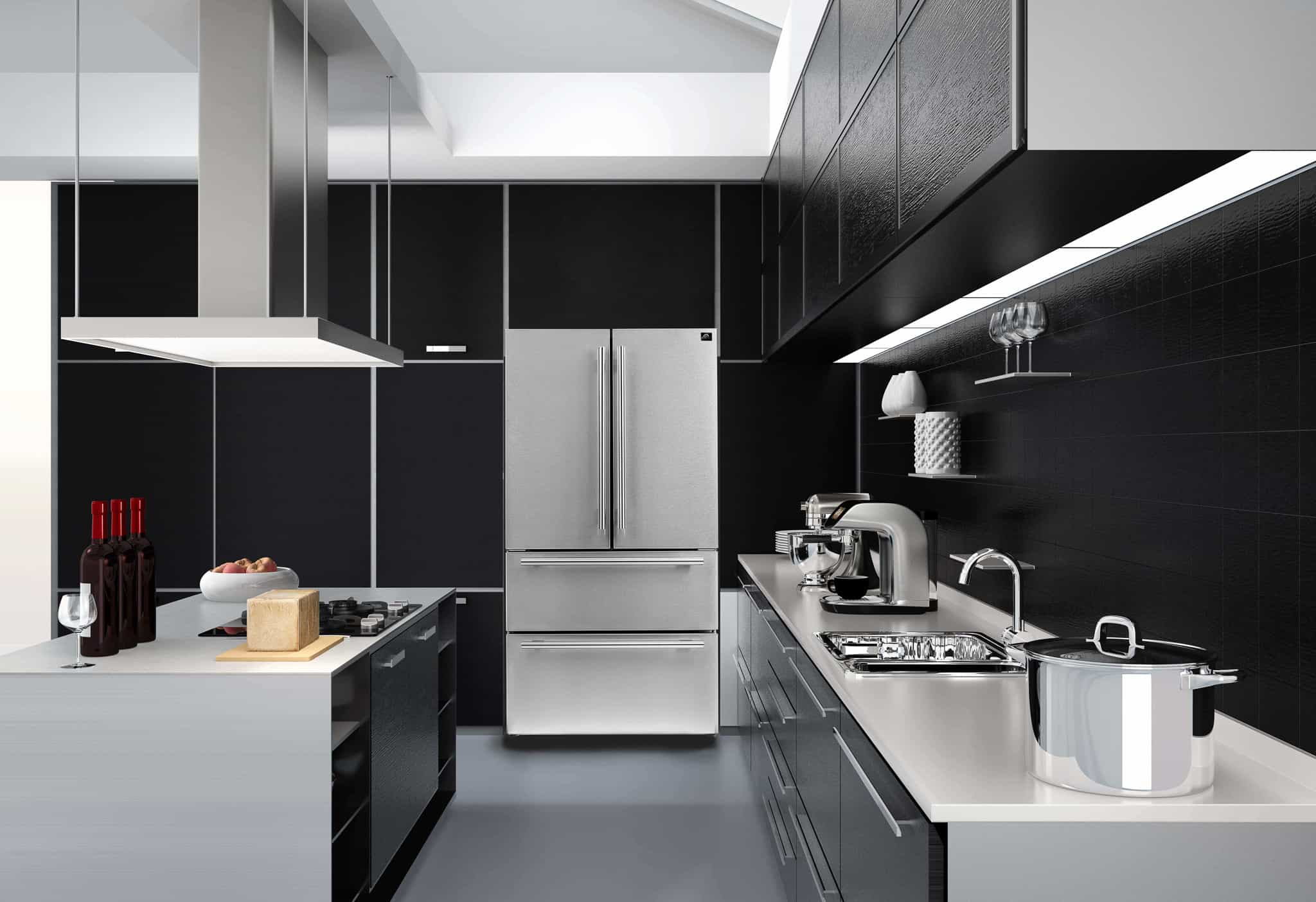 Stainless steel kitchen appliance suite featuring refrigerator and range hood