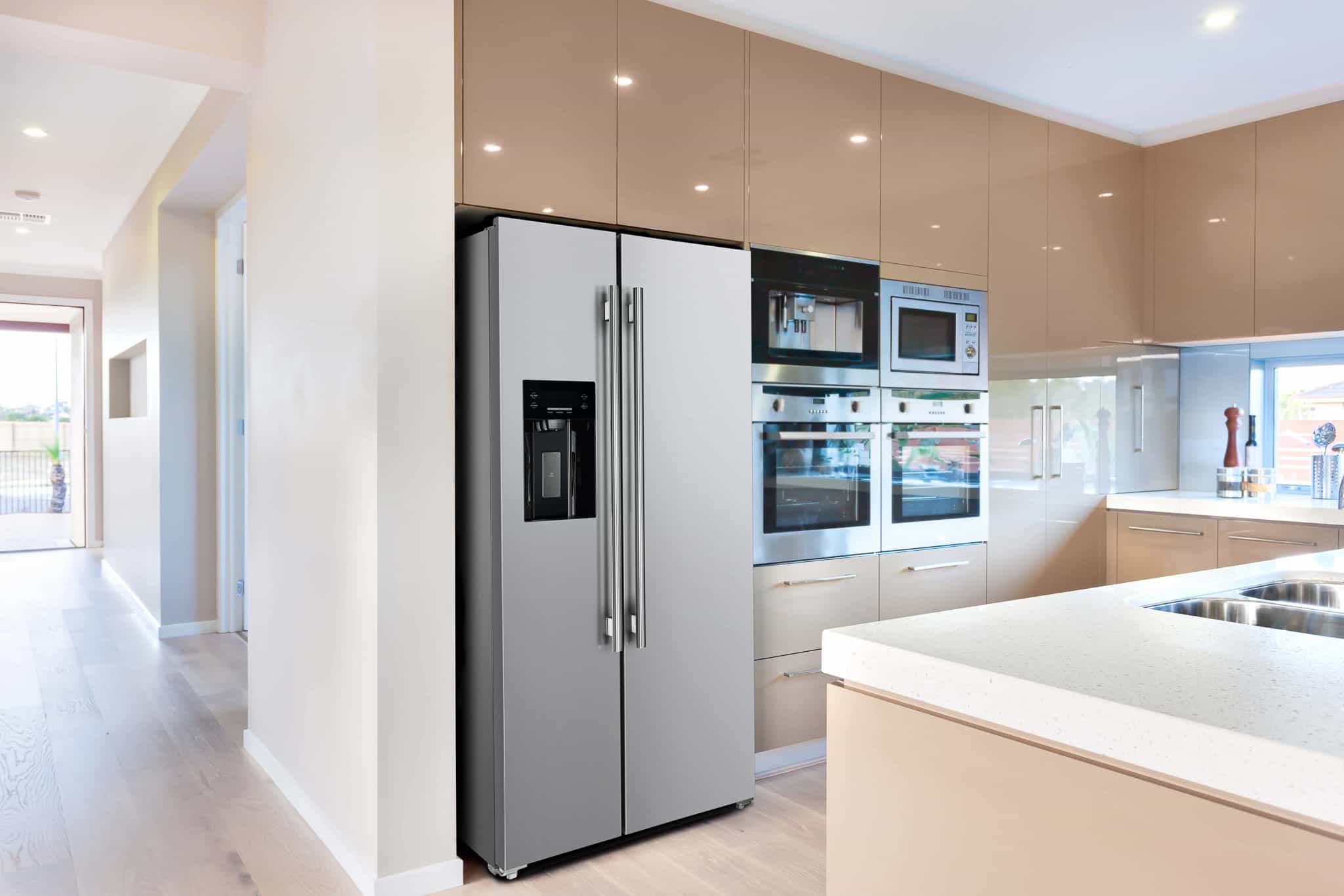 Stainless steel double-door refrigerator with water dispenser in a modern kitchen