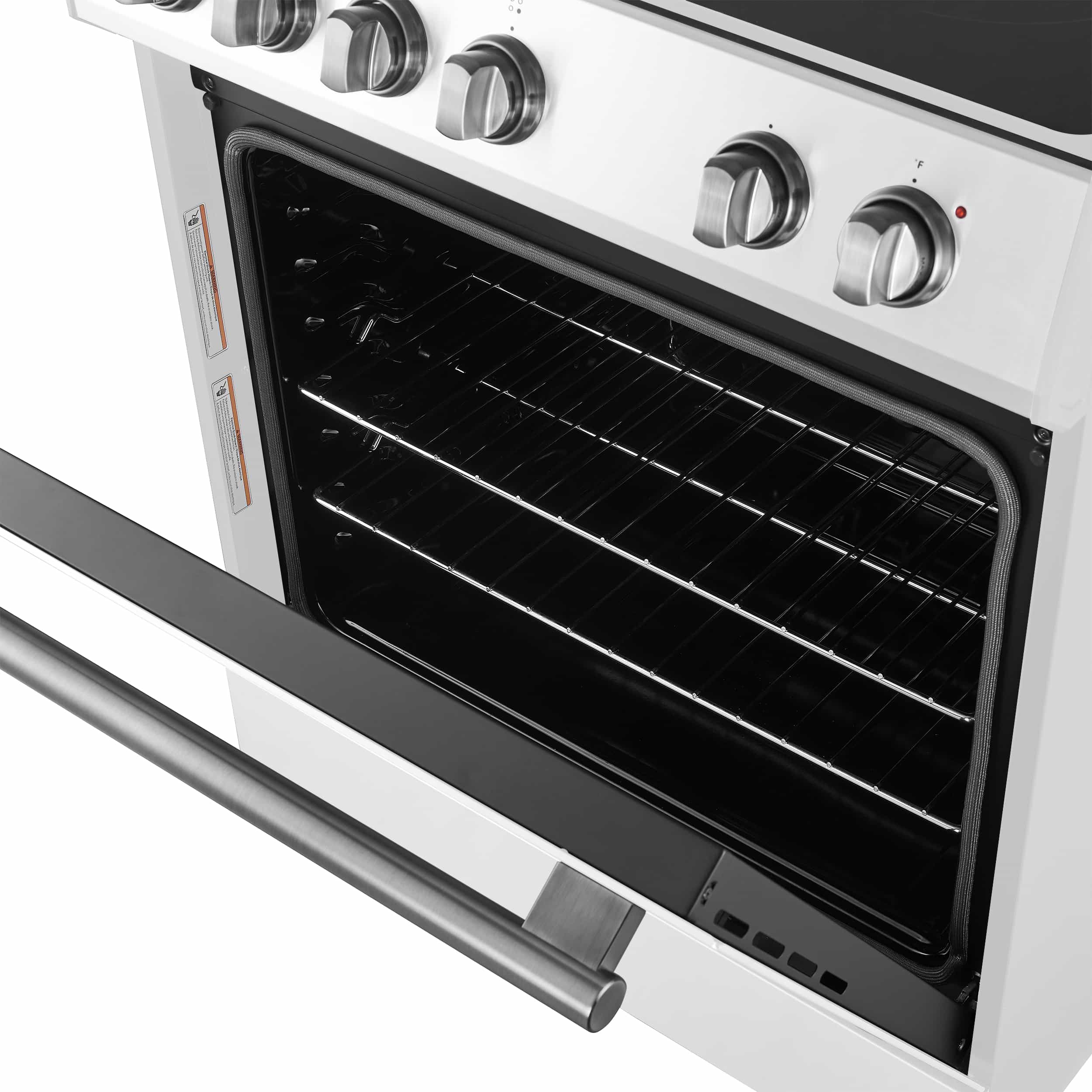 White electric range oven interior with black racks and stainless oven door handle