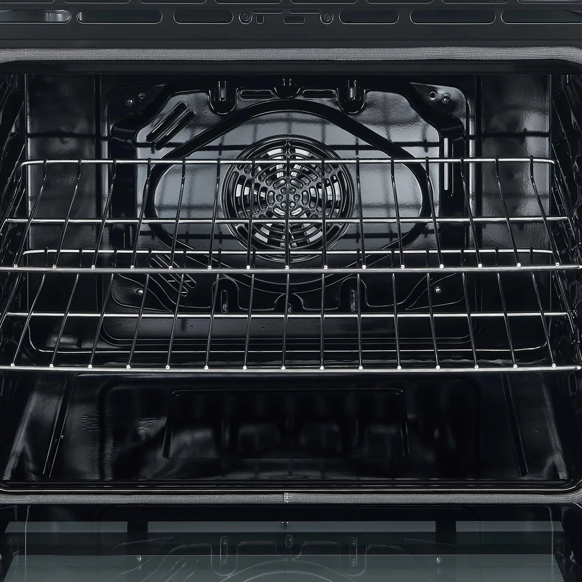 Electric oven interior with fan-style heating element and wire racks