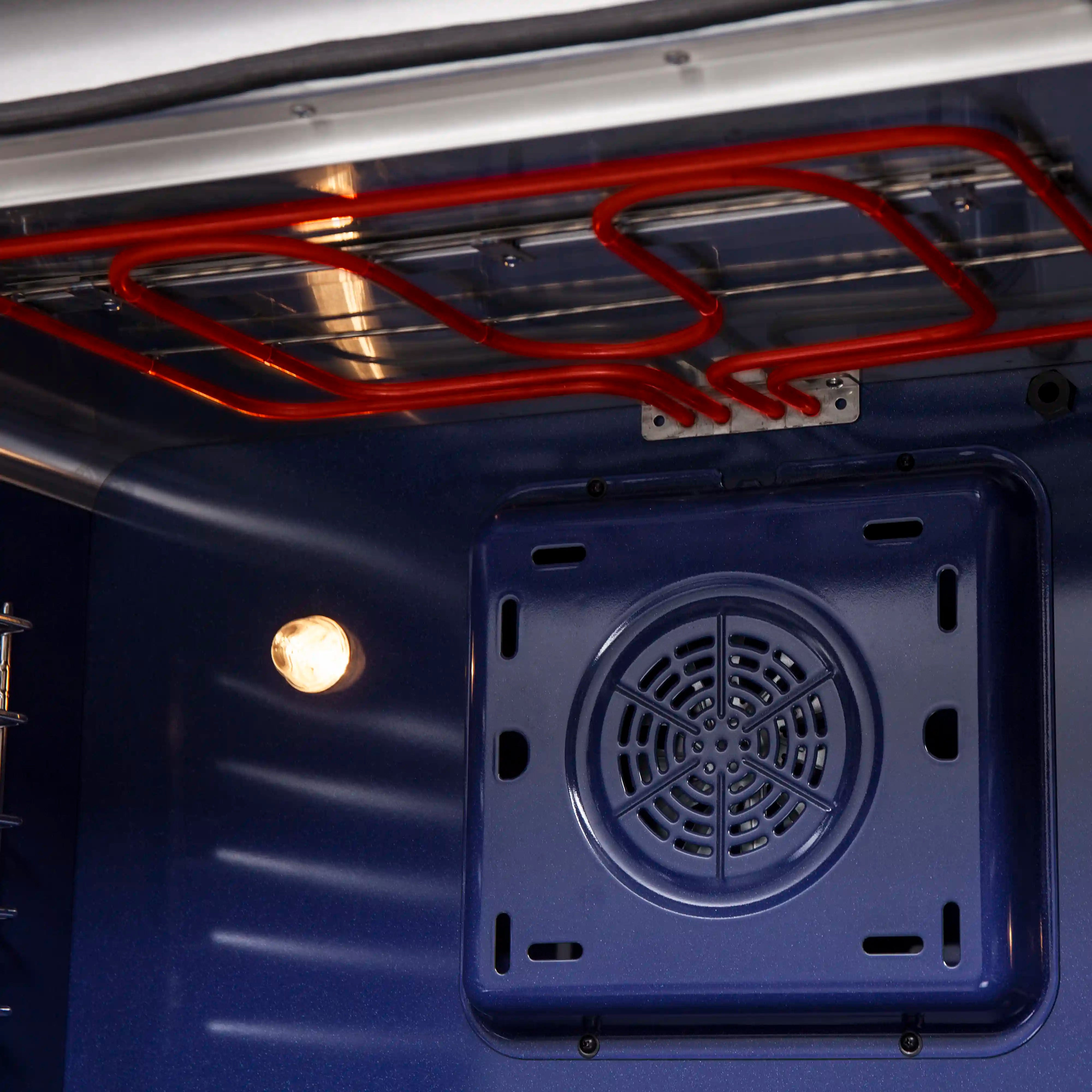 Electric range oven fan vent with square access panel in blue interior