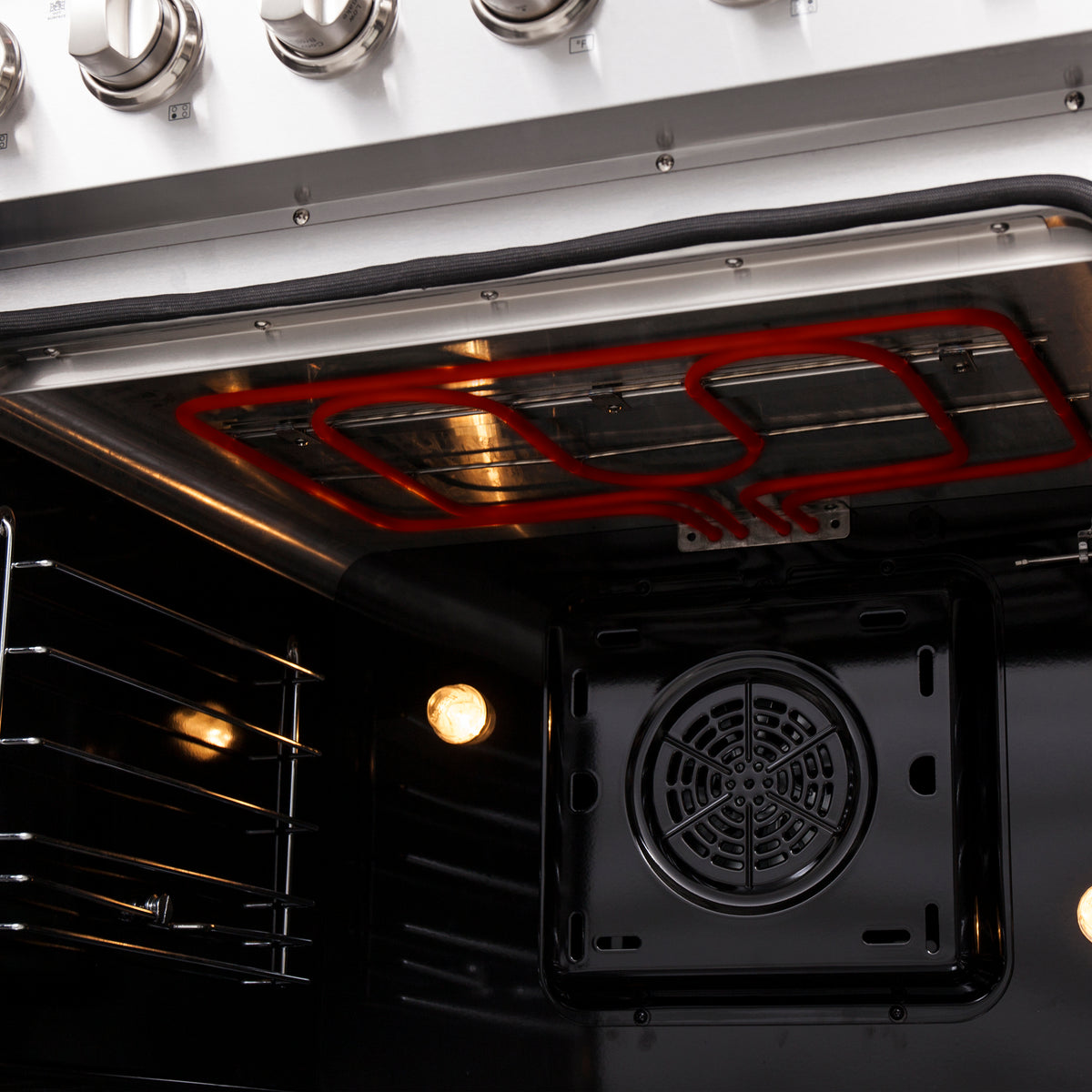 Convection oven interior with visible fan housing and red heating elements glow
