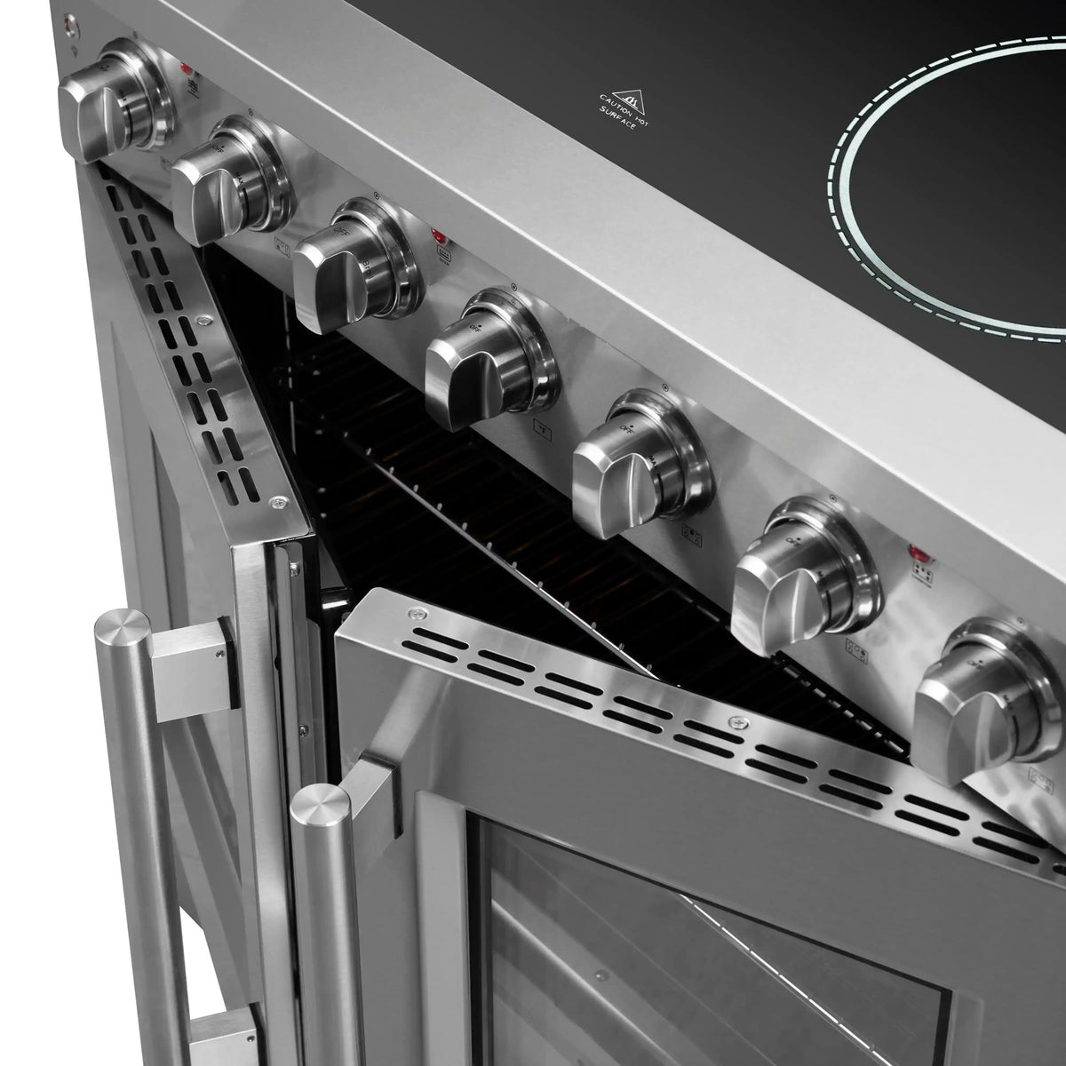 Open oven with stainless control knobs on an electric range