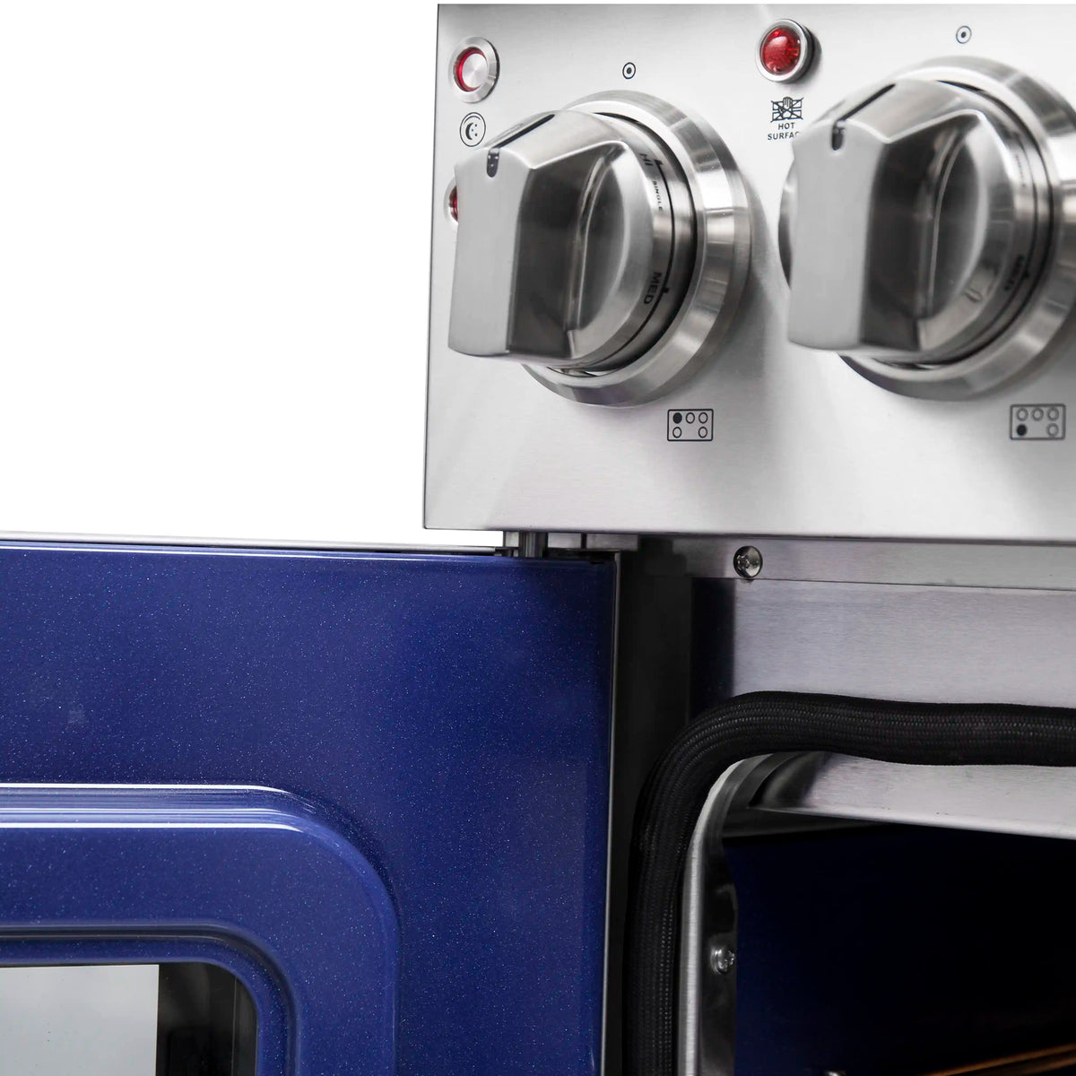 Electric range control knobs on stainless panel above open oven door frame