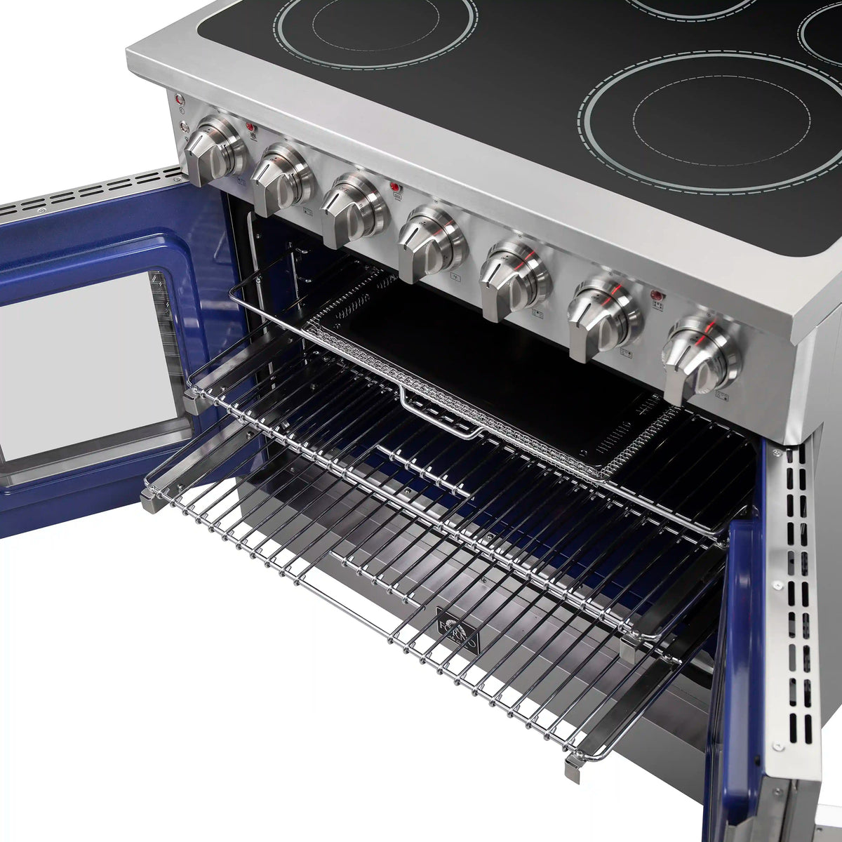Open oven with wire rack shelves and burner controls above on stainless cooktop