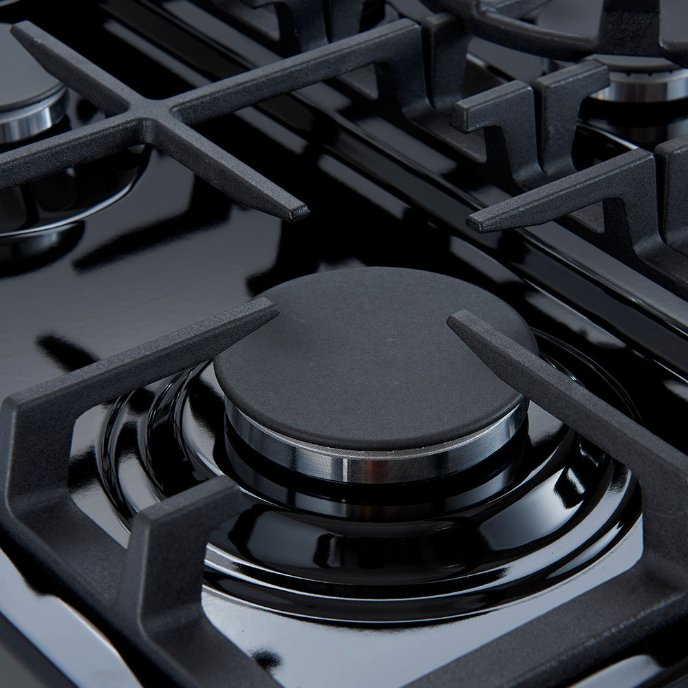 Close-up of black gas burner grate and round burner cap with glossy control ring.