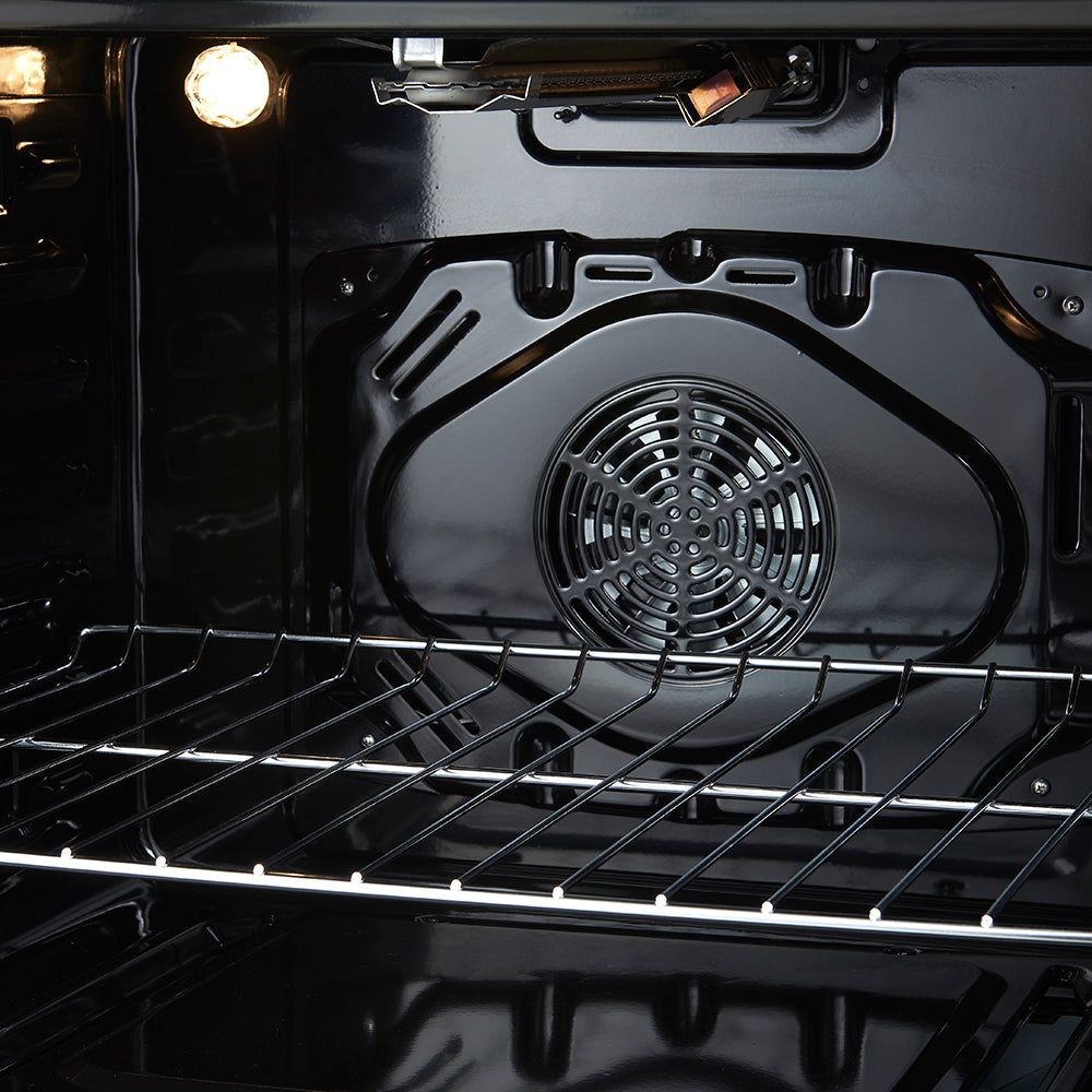 Black oven interior with rear ventilation fan and wire rack