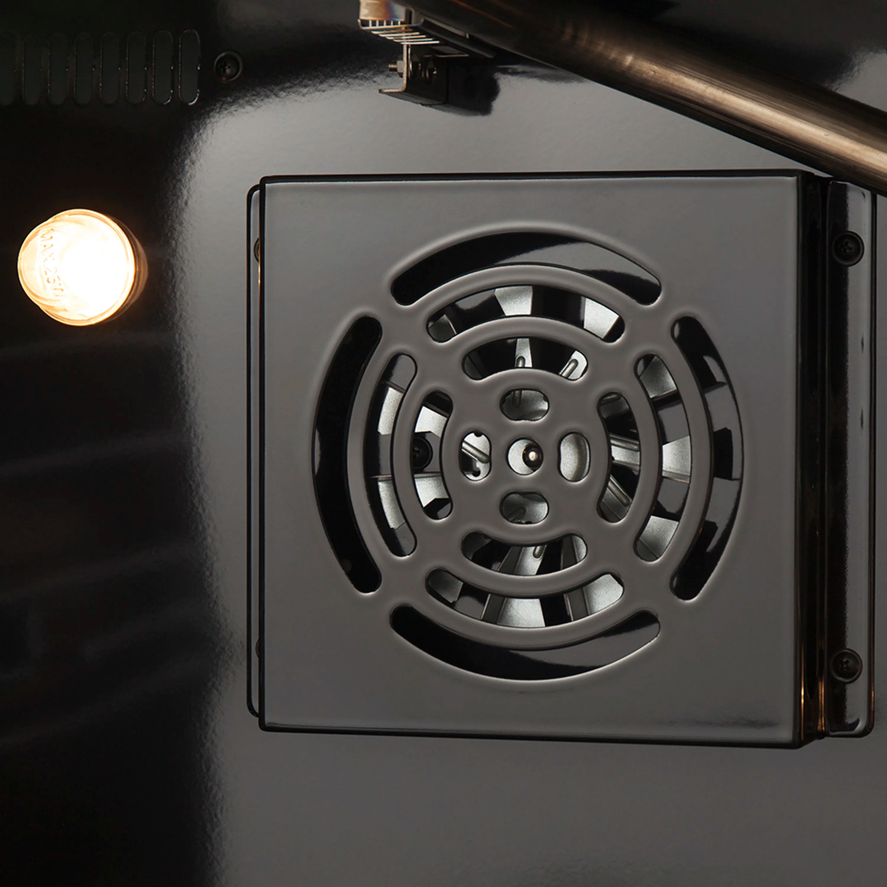 Oven fan and vent cover inside stainless gas range, black interior